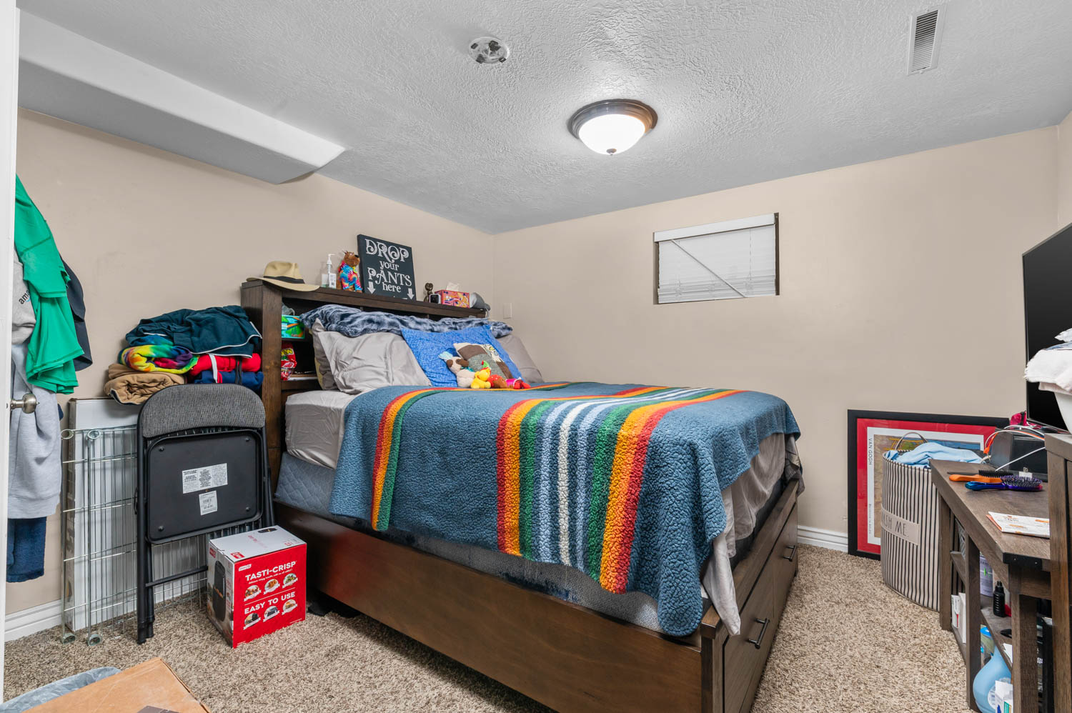 Carpeted room featuring a window with blinds, recessed ceiling light, and neutral wall paint