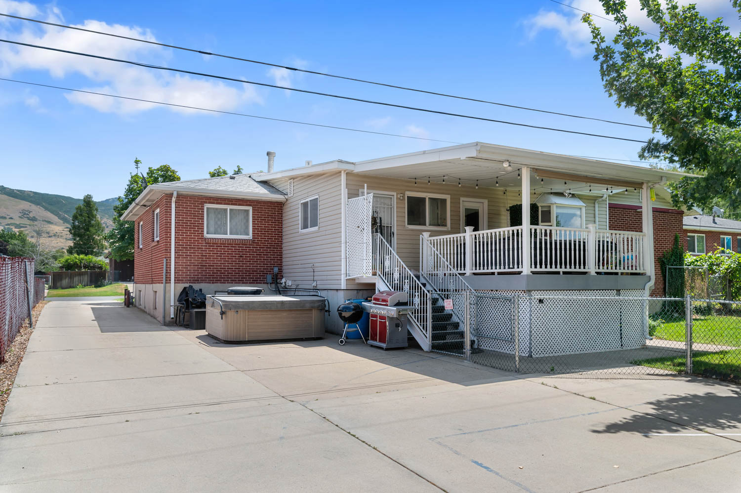 Expansive concrete driveway alongside a brick and siding exterior