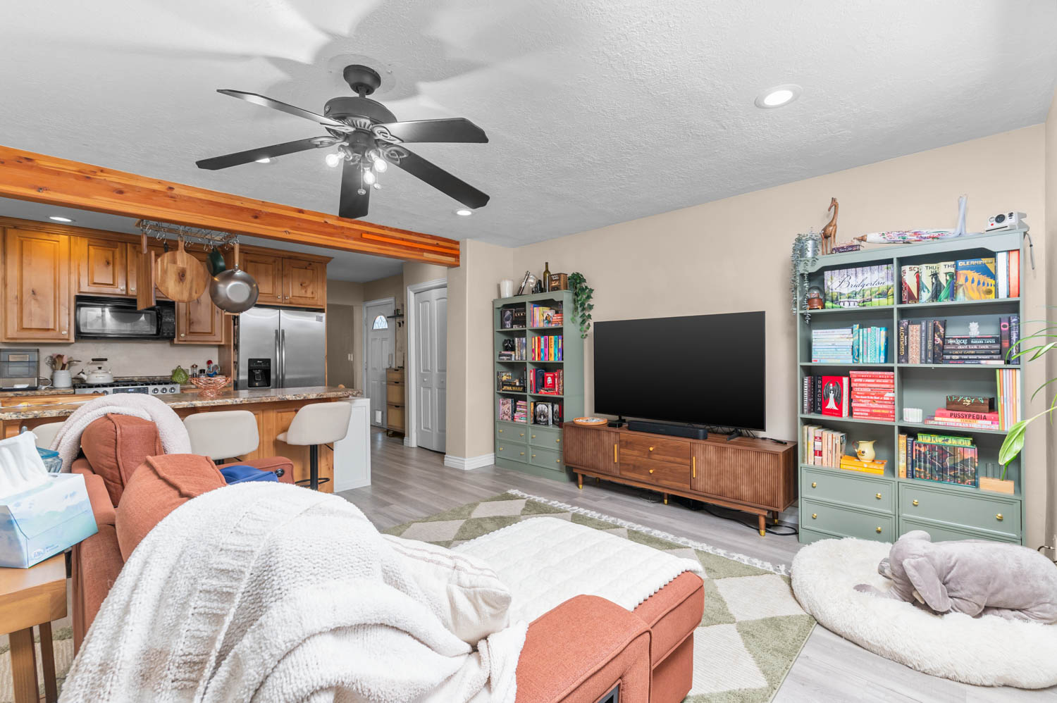 Open-concept living area featuring light wood-finish flooring and recessed lighting