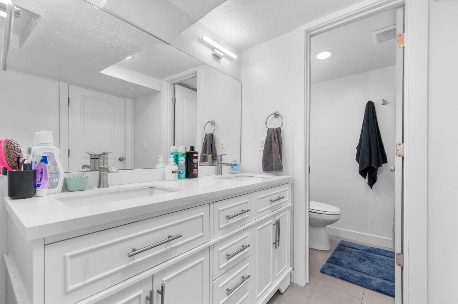 Dual vanity with white cabinetry and integrated sinks