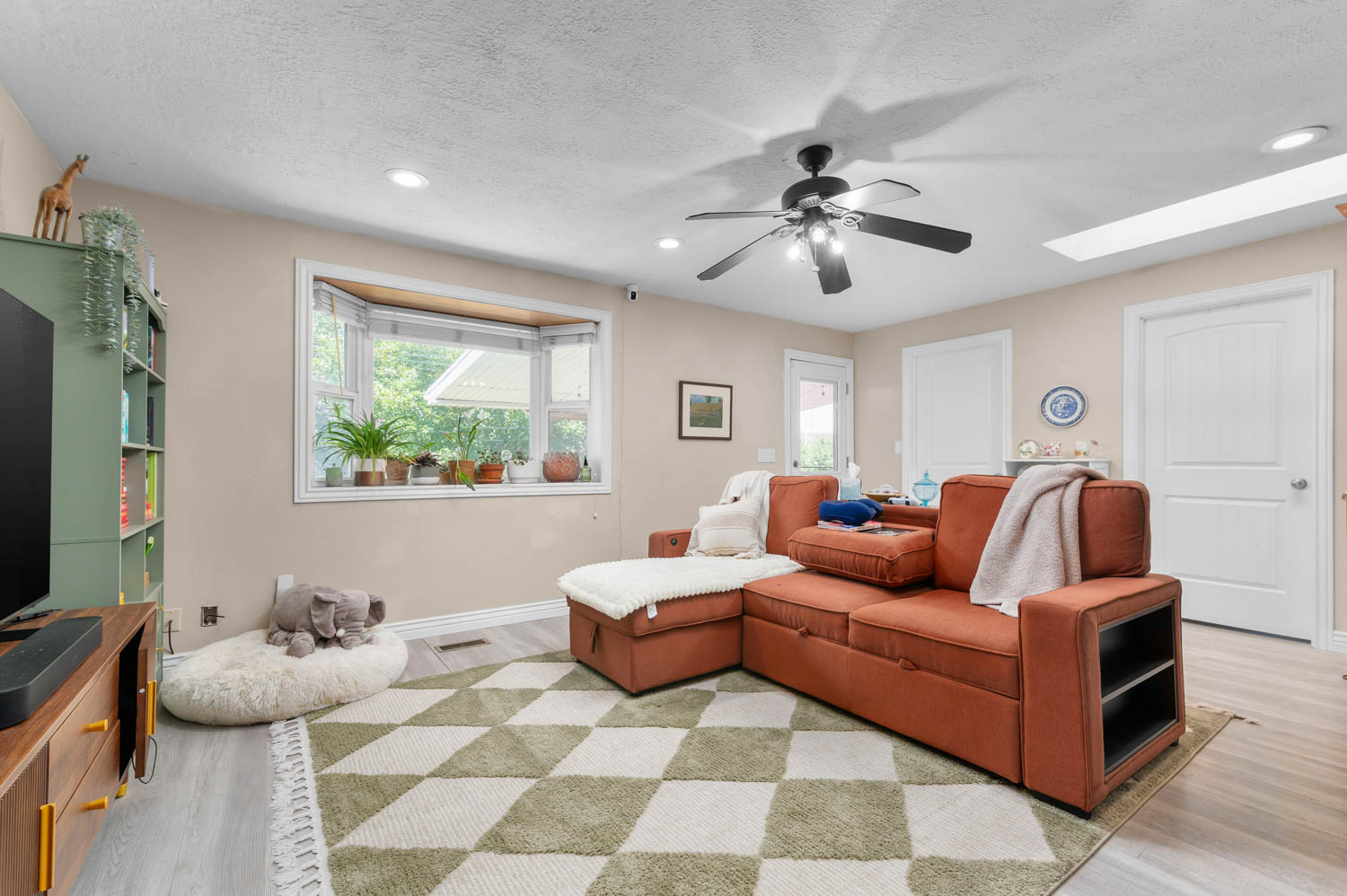 Living area featuring a bay window, recessed lighting, and a ceiling fan