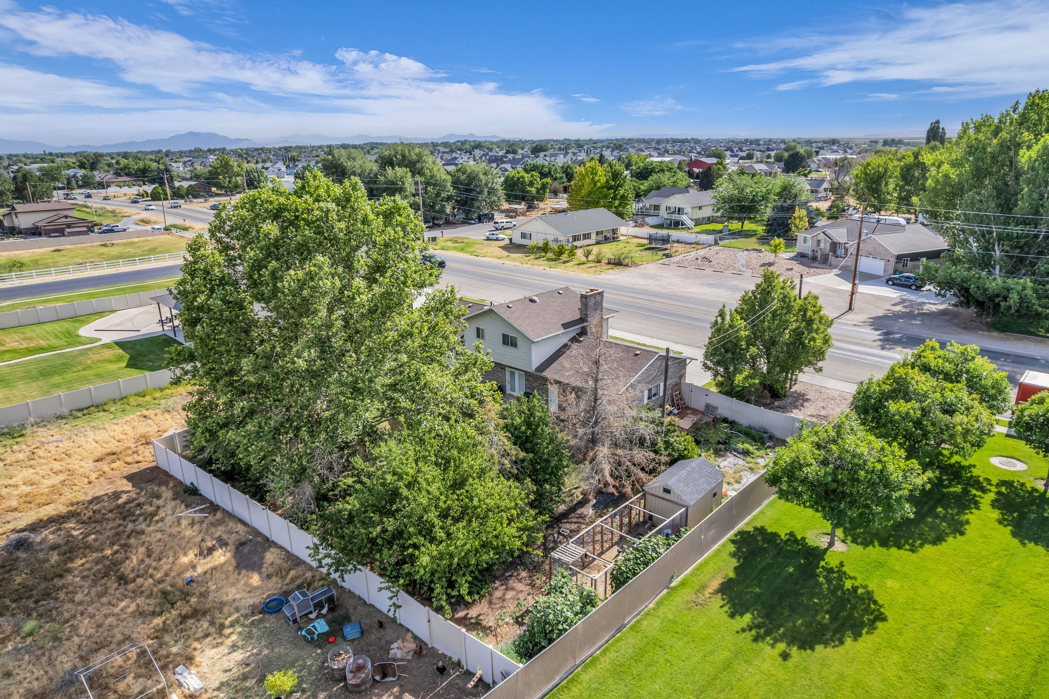 Expansive property featuring mature trees and a substantial fenced yard