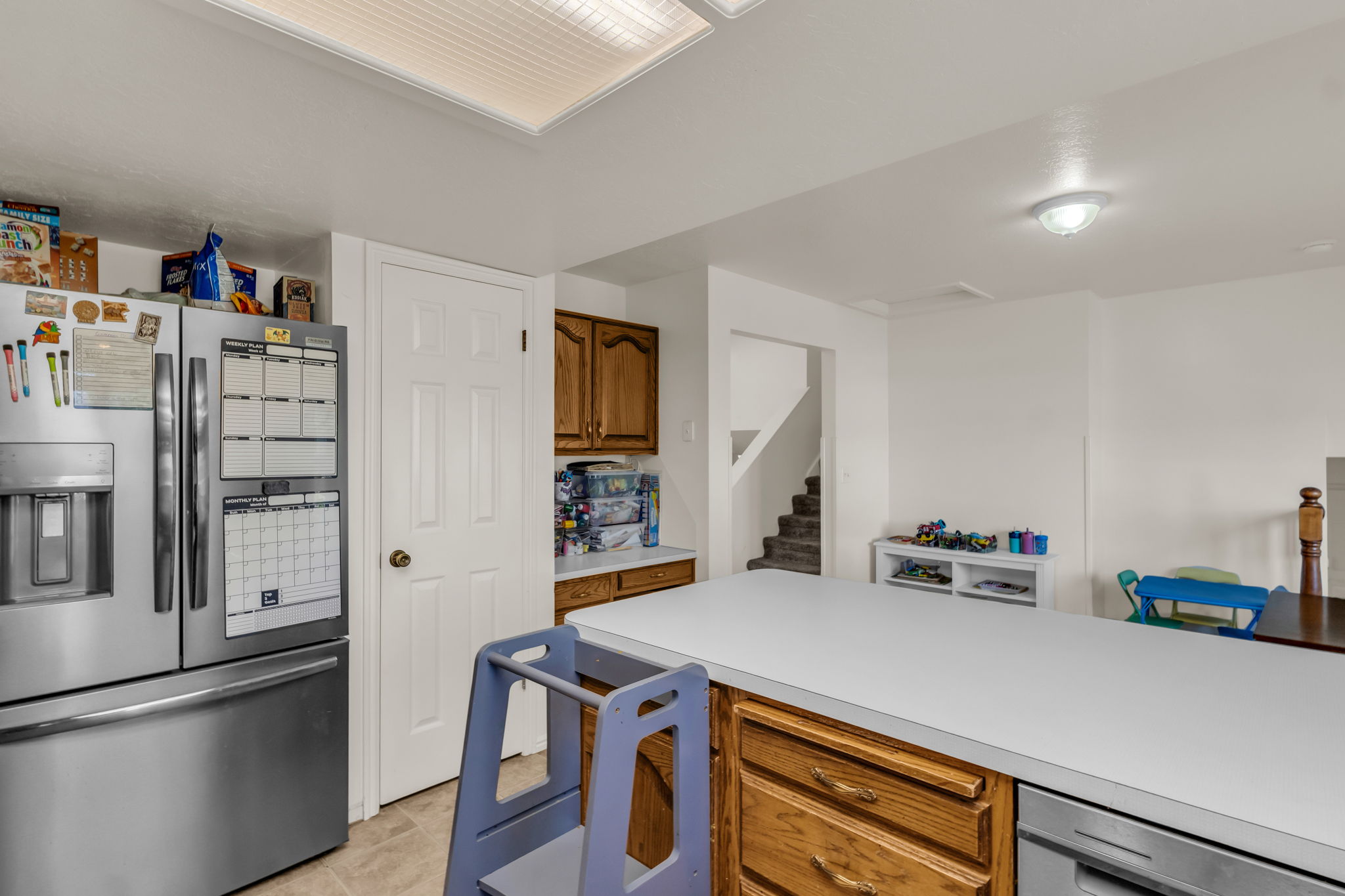 Kitchen featuring a large central island with solid surface countertop, wood cabinetry, and stainless steel appliances