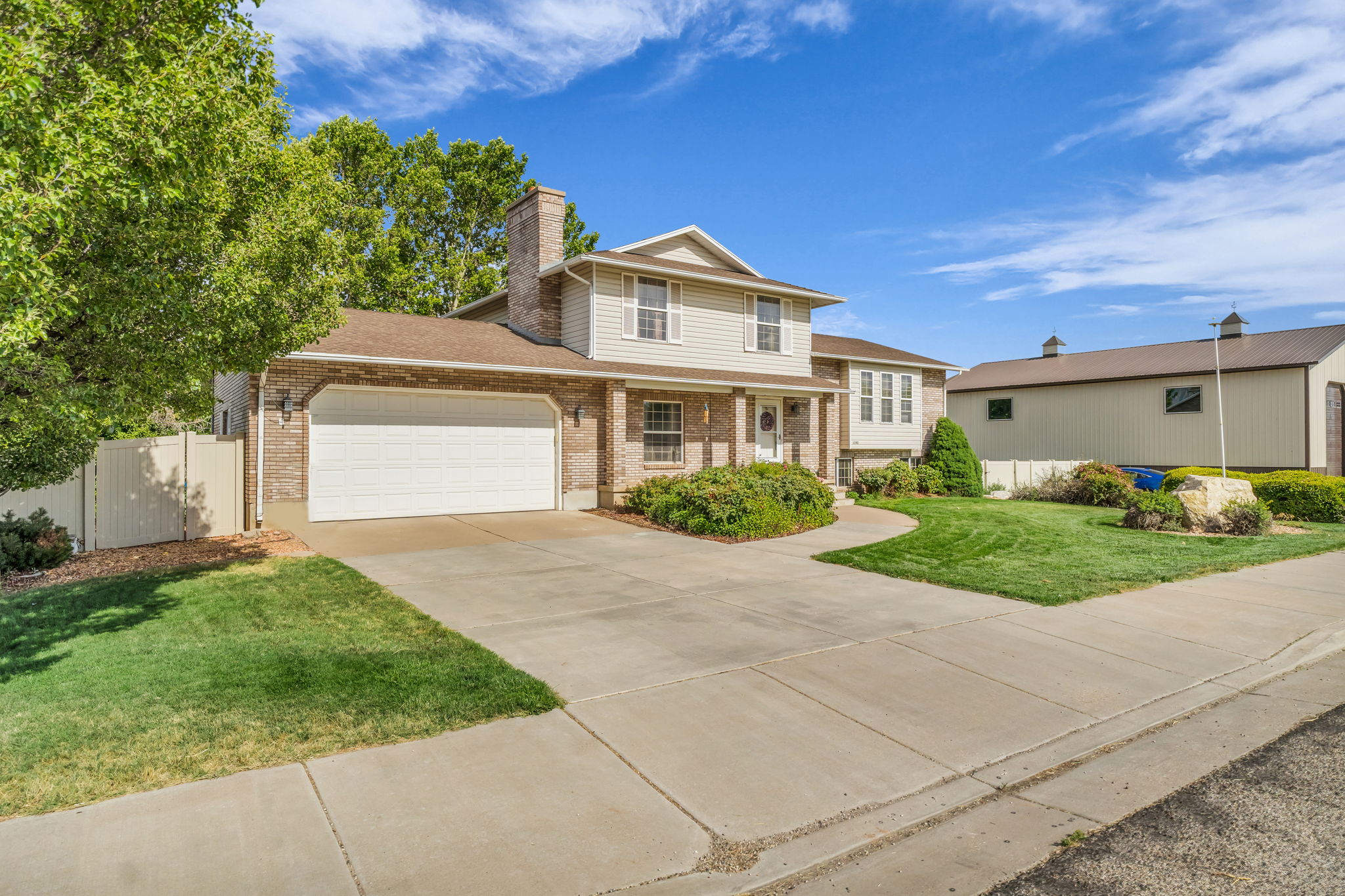 Two-story residence featuring brick and siding exterior, an attached two-car garage, and a concrete driveway
