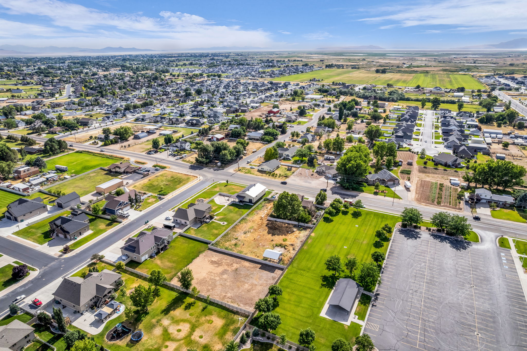 Expansive aerial showcasing a residential neighborhood with established homes and developing lots