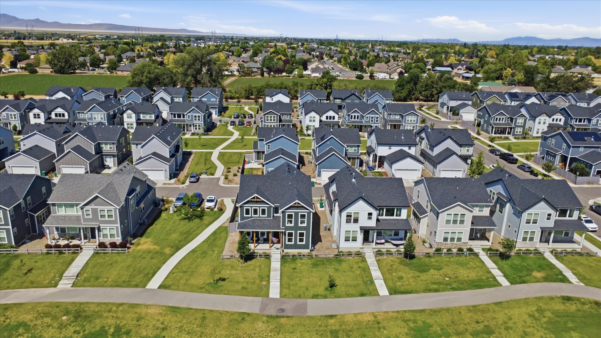 Contemporary residential development featuring a collection of two-story homes with varied exterior finishes and attached garages