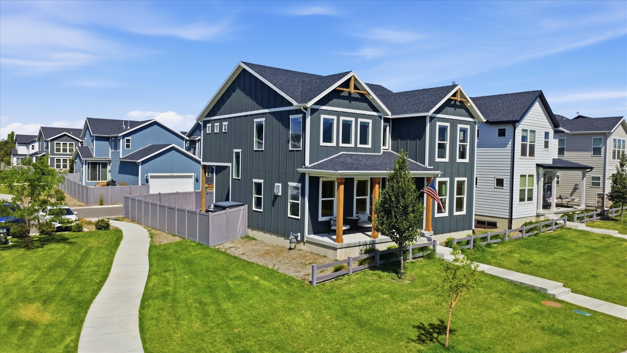 Modern two-story residence with dark siding and white trim