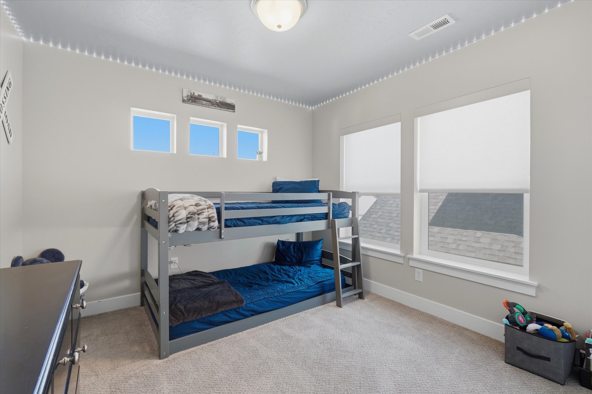 Neutral wall paint with crown molding and recessed lighting