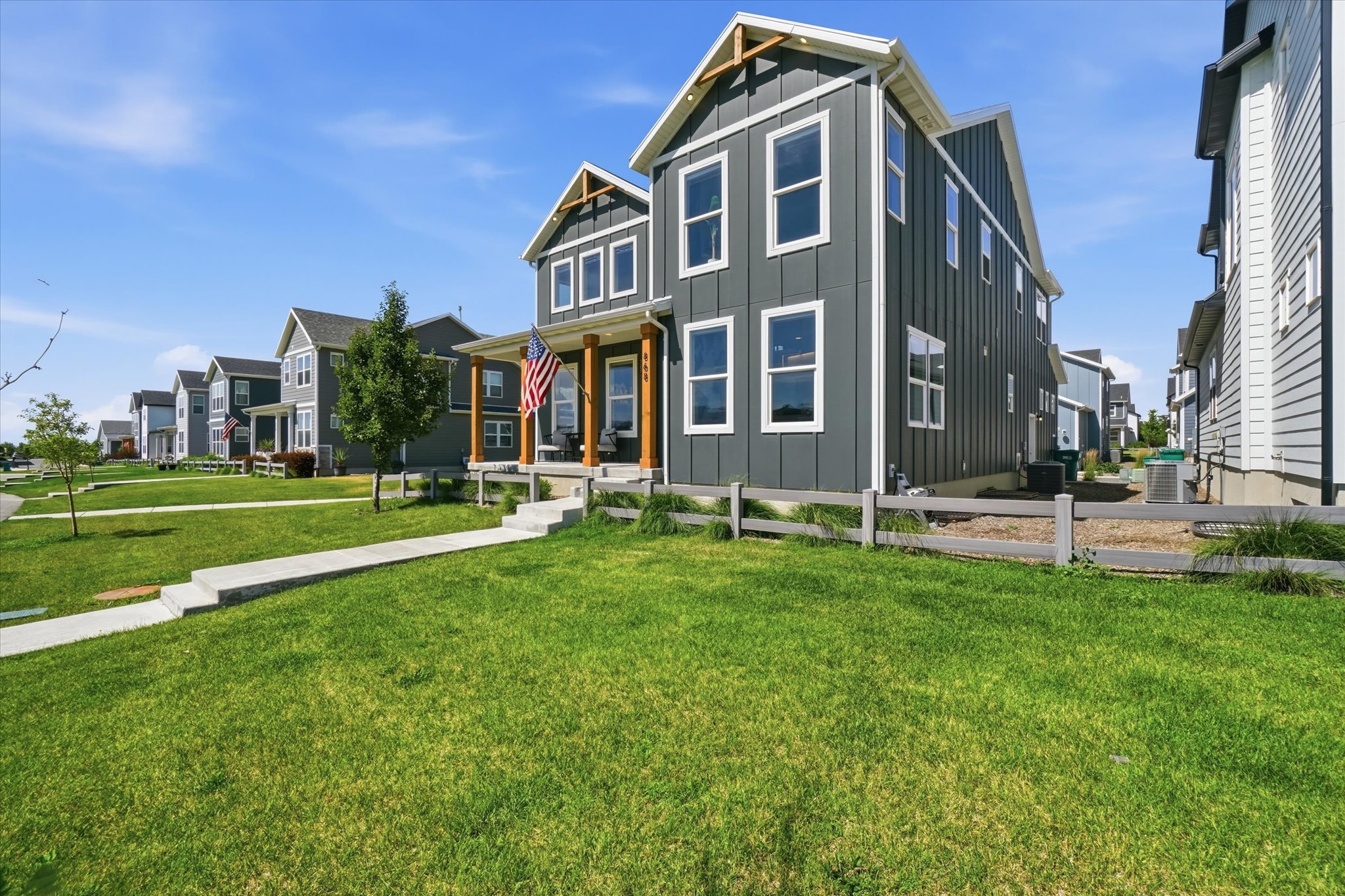 Modern two-story residence featuring dark vertical siding and white trim