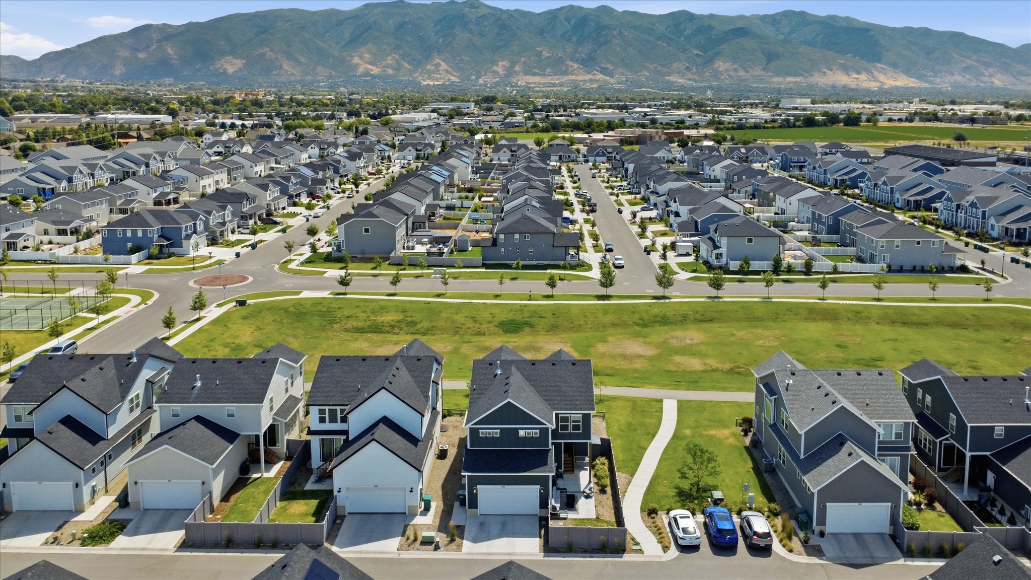 Modern residential community with uniform architectural styles and dark-shingled roofs