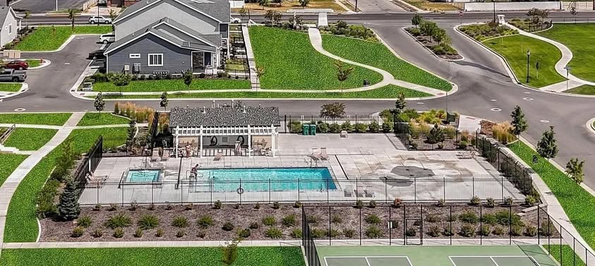 Outdoor recreation area featuring a fenced swimming pool, separate spa, and an adjacent tennis court