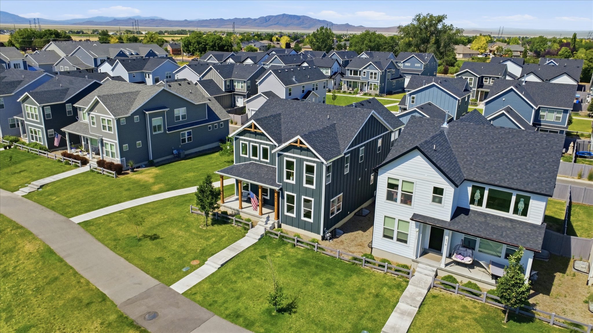Modern residential development featuring multiple two-story homes with pitched roofs and varying exterior siding