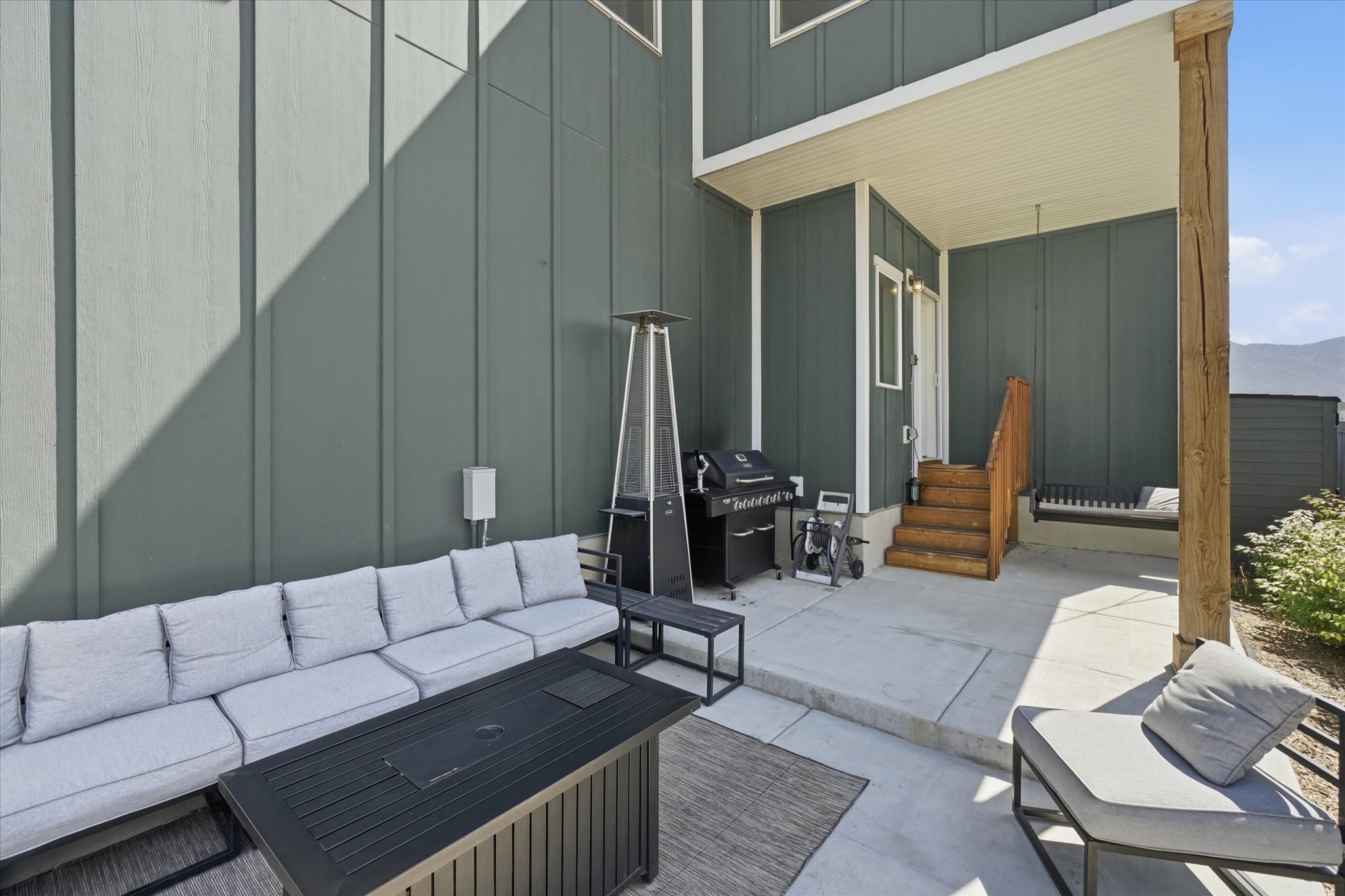 Concrete patio with board and batten siding