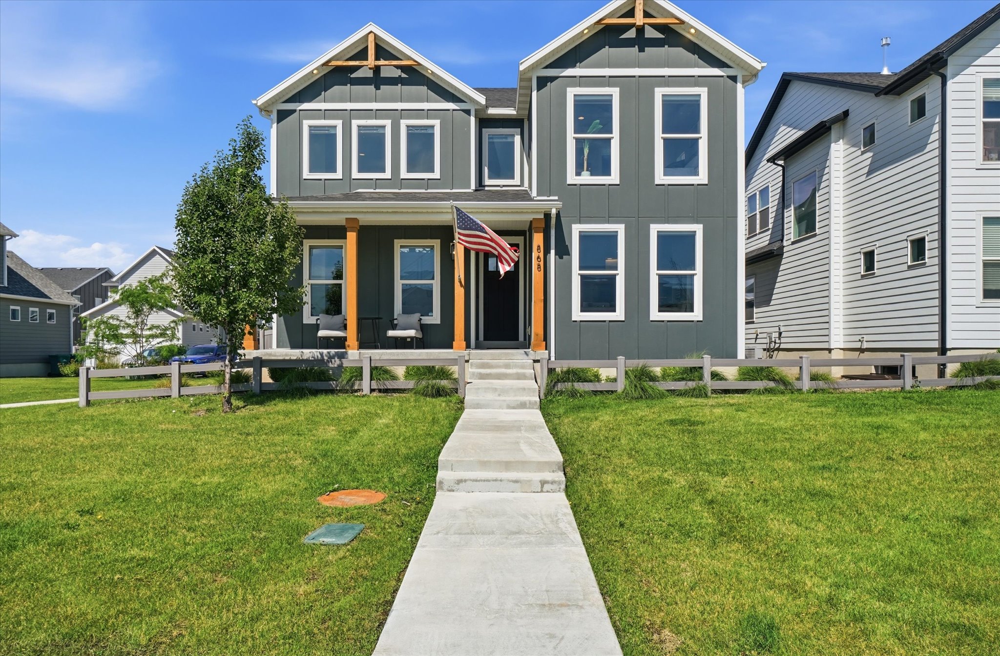 Two-story home with a dark gray exterior and white trim
