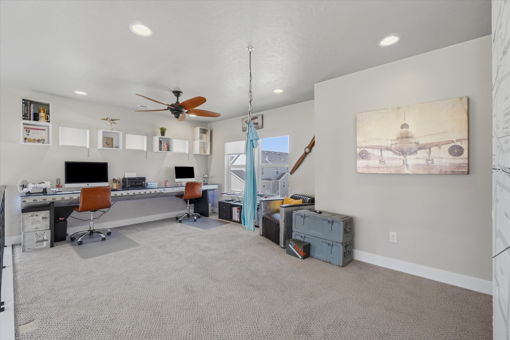 Spacious room featuring light gray carpeting, recessed lighting, and a ceiling fan