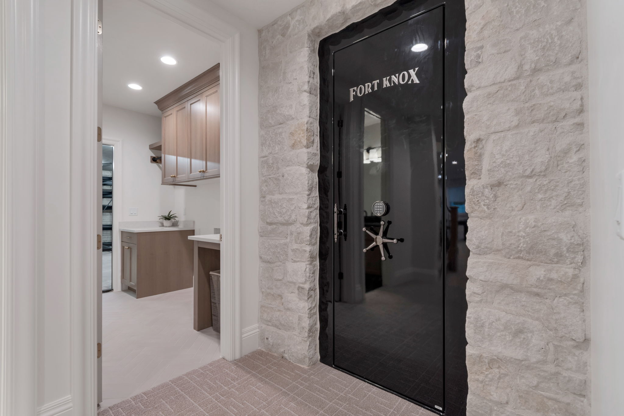 Custom vault door with a stone-clad surround