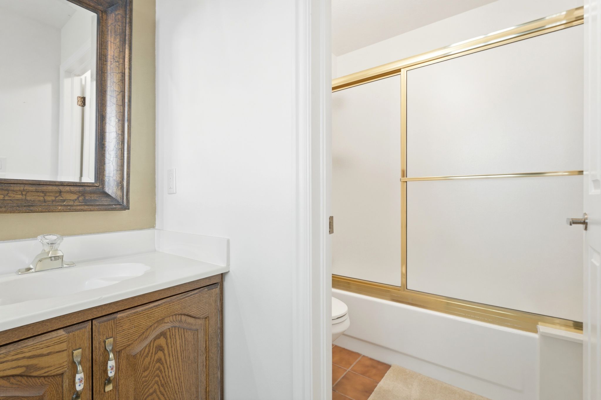 Upper level full bathroom featuring a vanity with wood-finish cabinetry, a white countertop, and an integrated sink basin