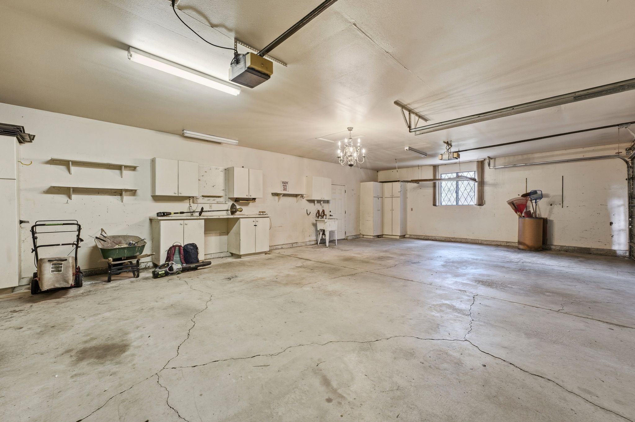 Spacious 4-car garage featuring built-in cabinets