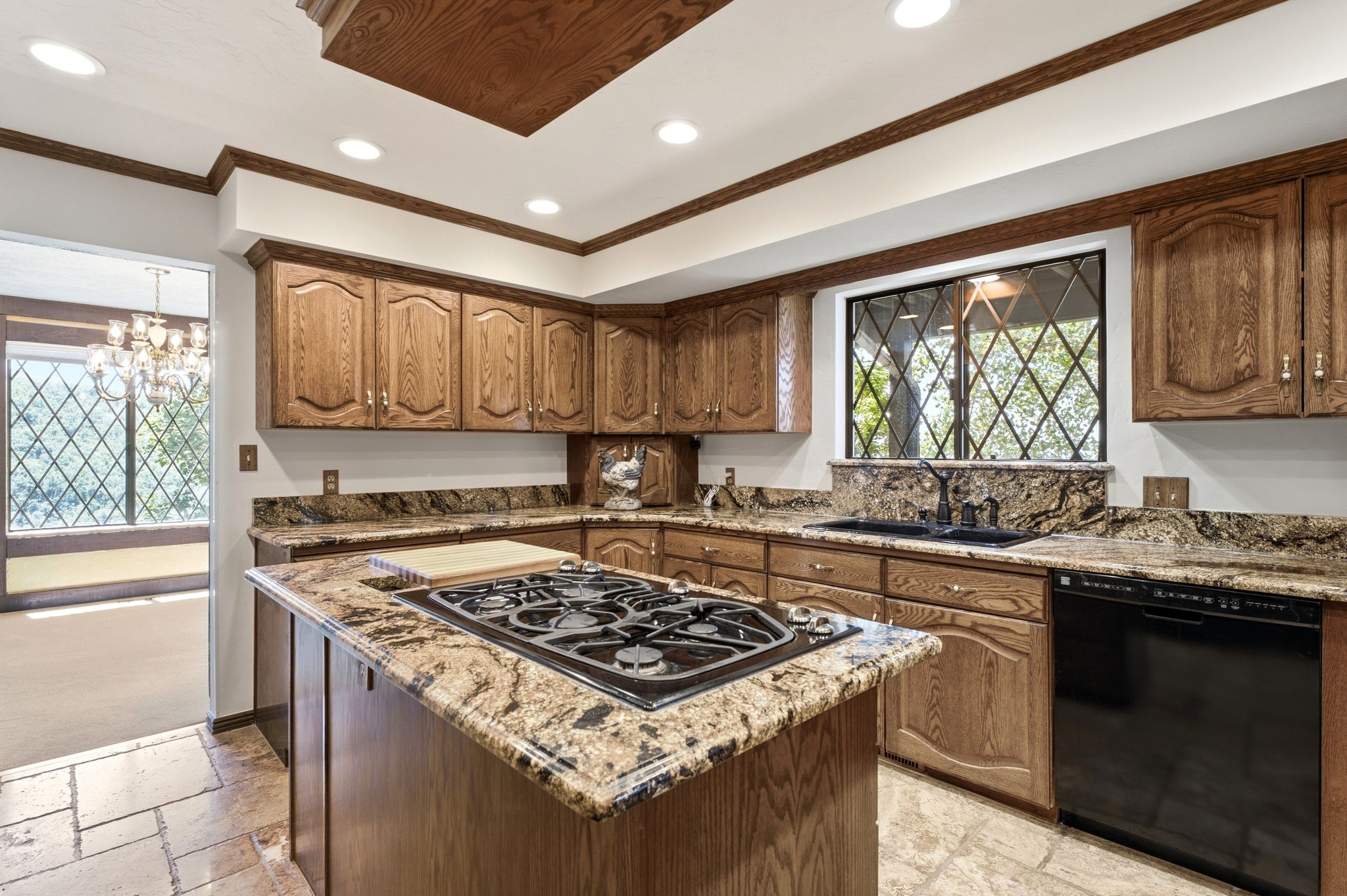 Kitchen featuring an island with a gas cooktop, granite countertops.