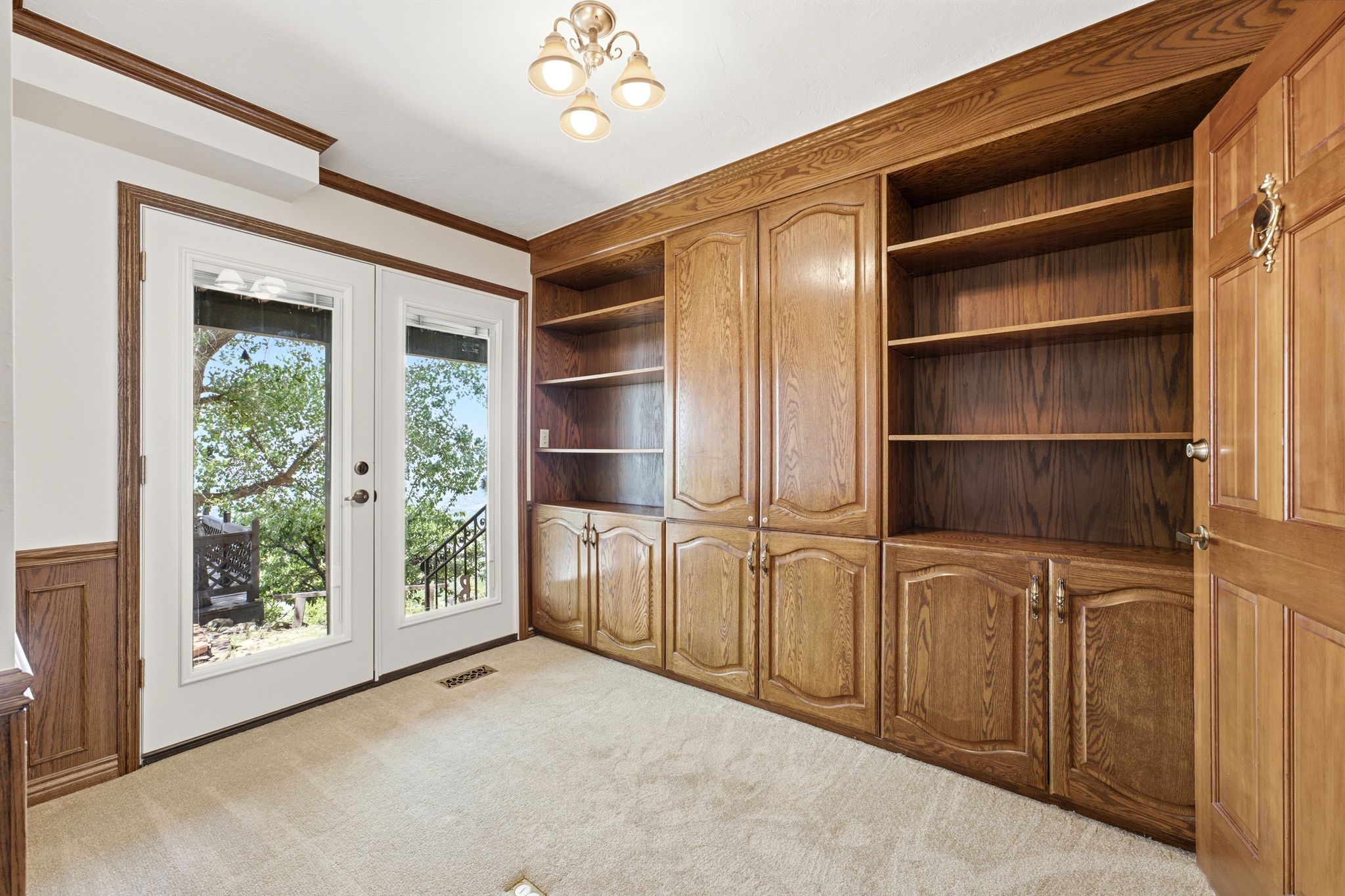 Main level office featuring built-in shelves and walks out to back patio