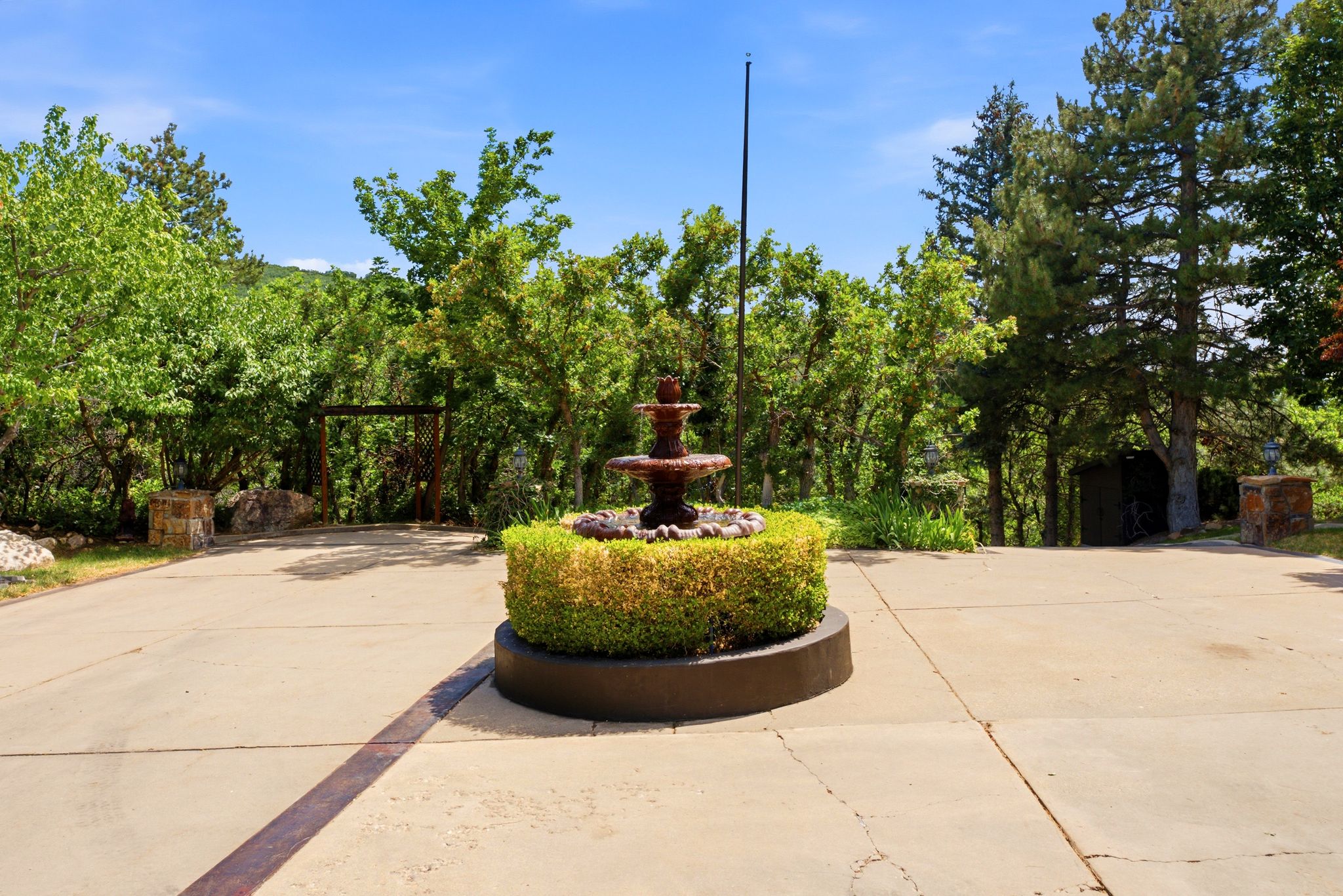 Front approach with a tiered fountain feature set within a circular drive
