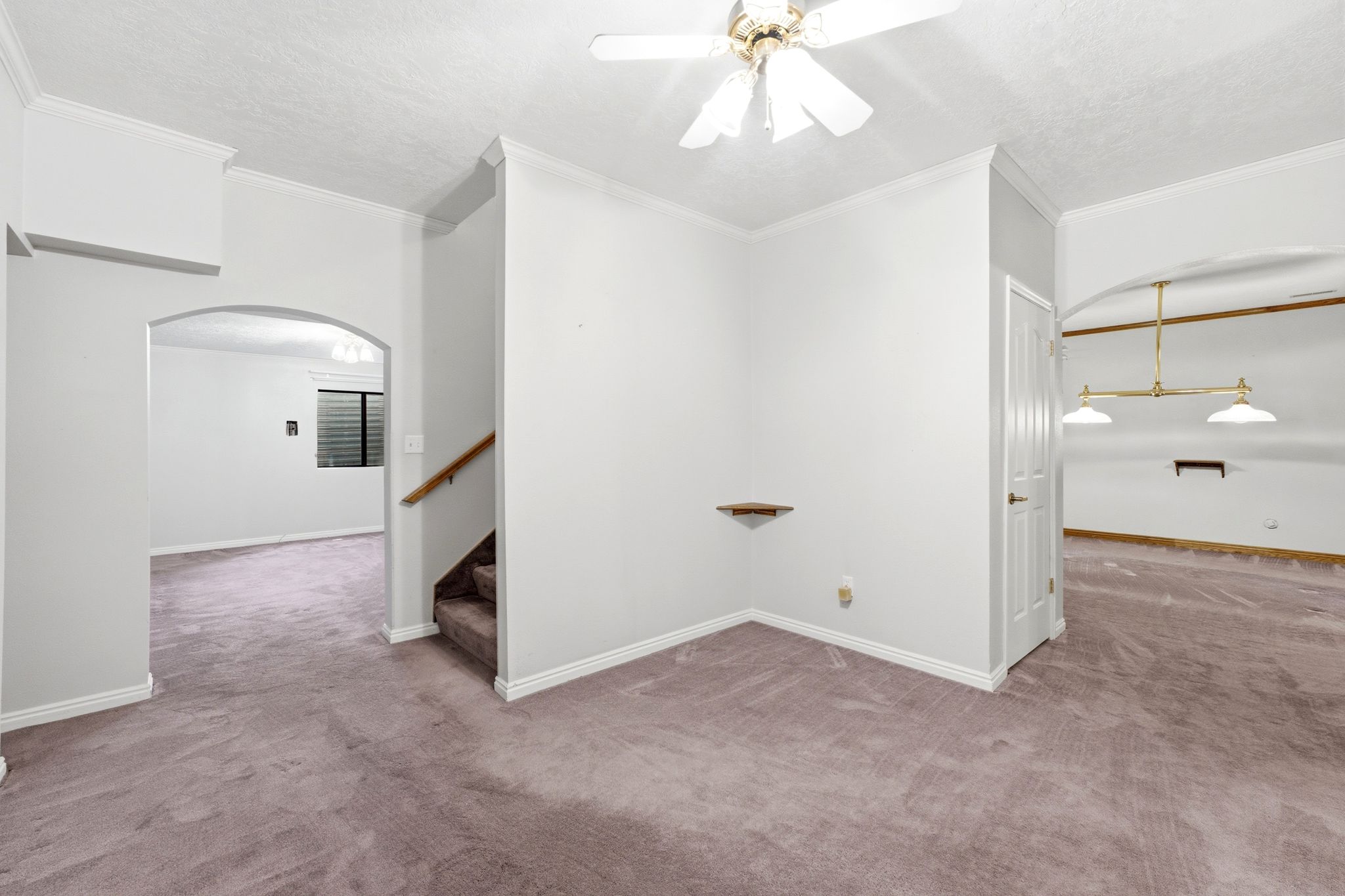 View of lower level family room and stairs to upper level