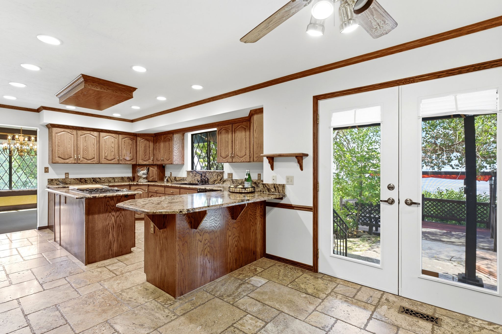 Kitchen featuring wood cabinetry, stone countertops, and tile flooring