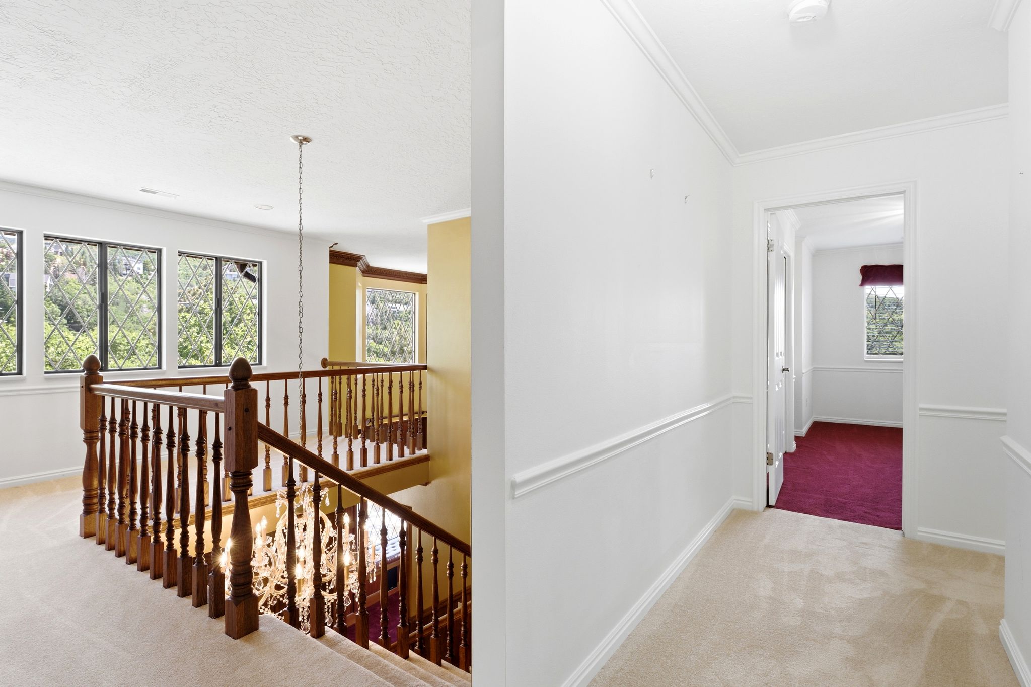 Upper-level landing with wood-finish balusters and newel posts
