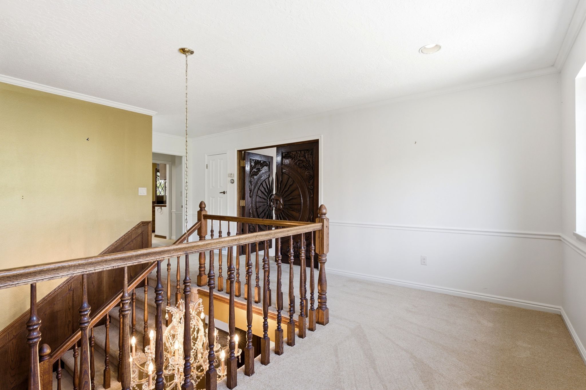 Upper-level landing showing door to the primary suite