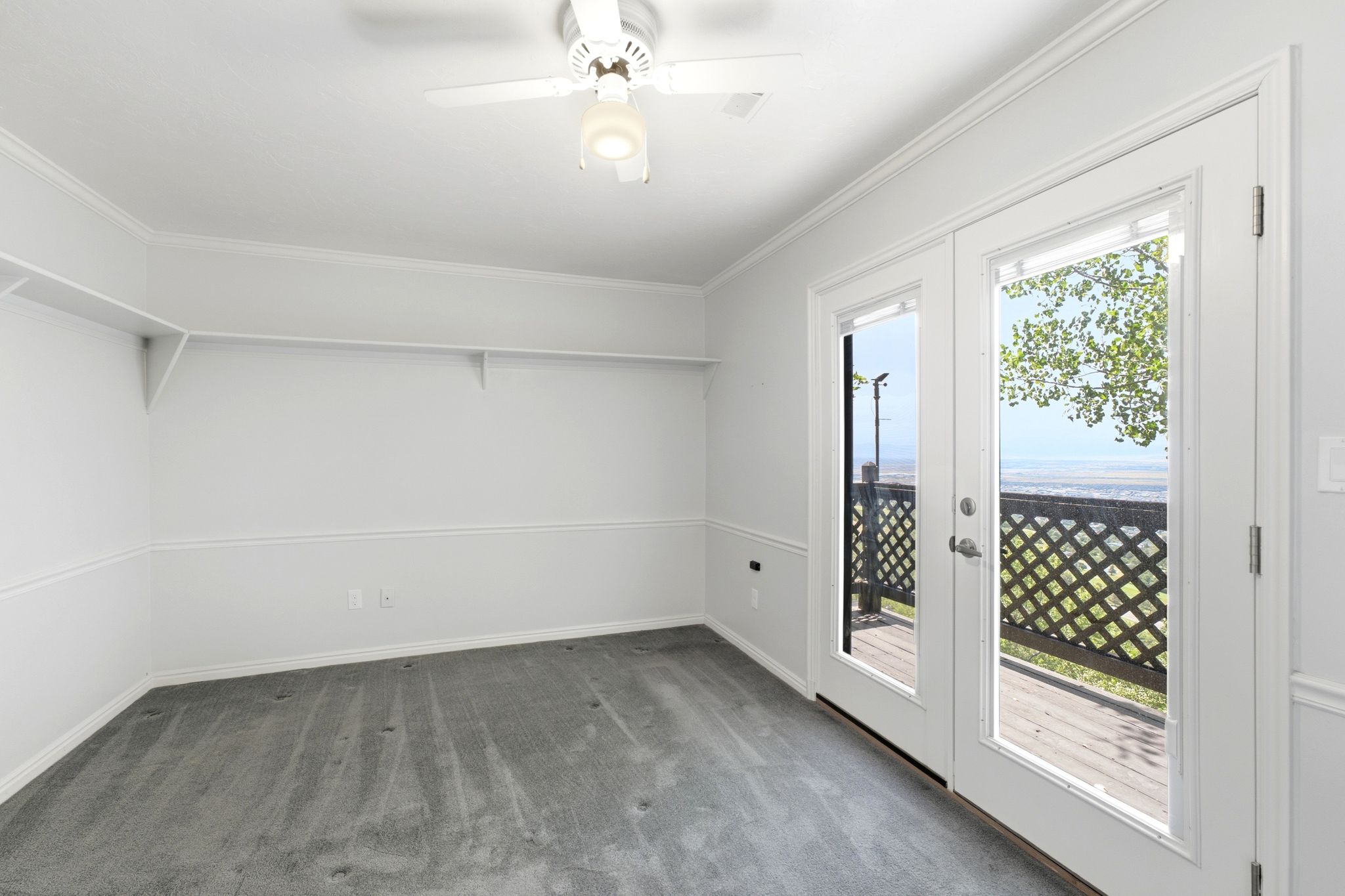 Bedroom with double French doors opening to exterior deck