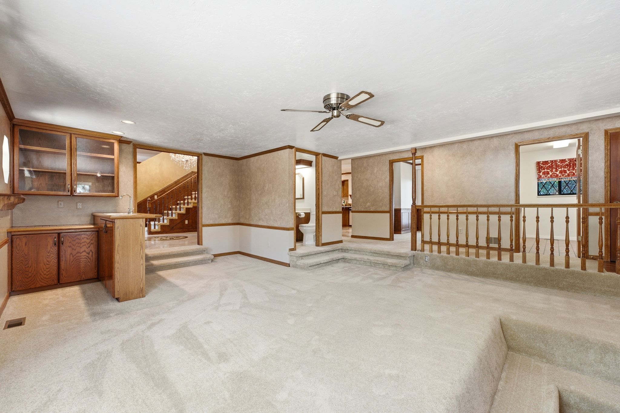 Main level family room - view of wet bar, entry, guest bathroom, office and laundry room