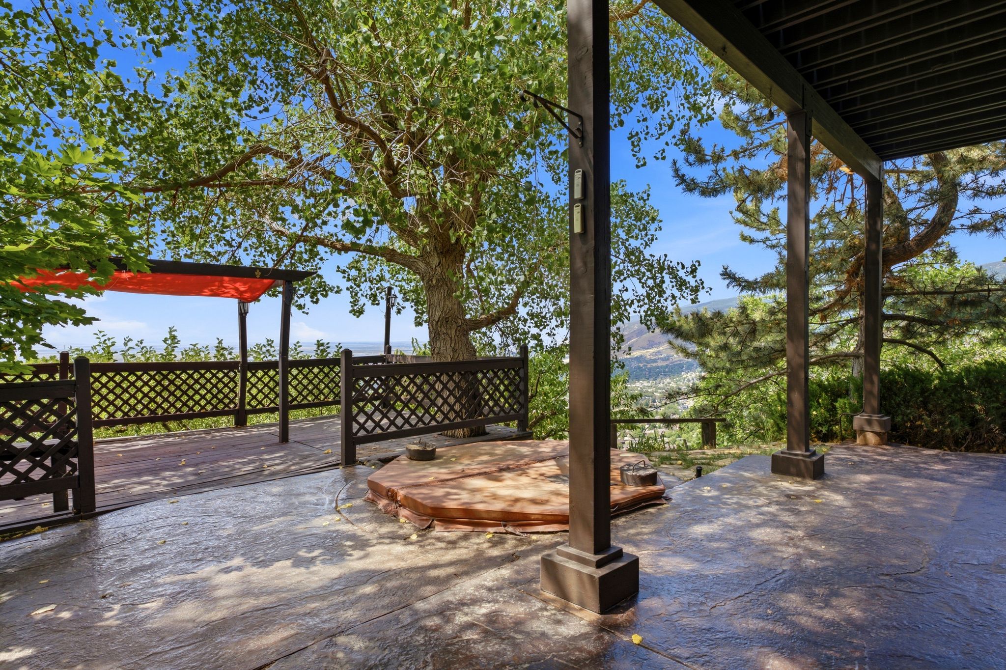 Expansive outdoor entertaining area featuring a covered patio walks out to main deck that overlooks the valley