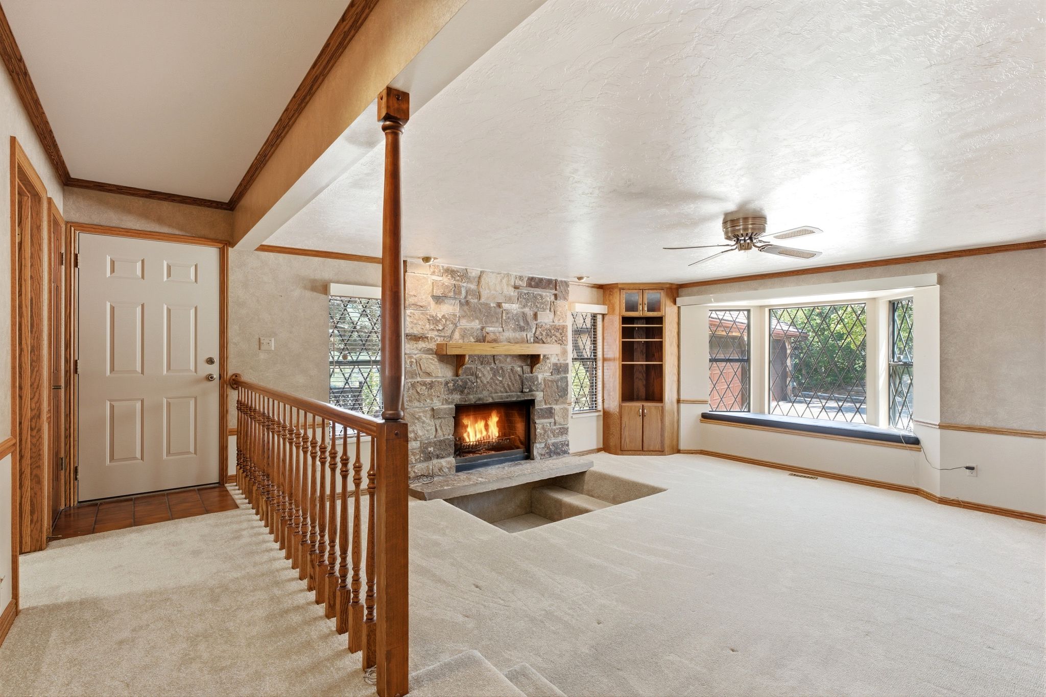 Main level family room with cozy sunken space in front of fireplace.