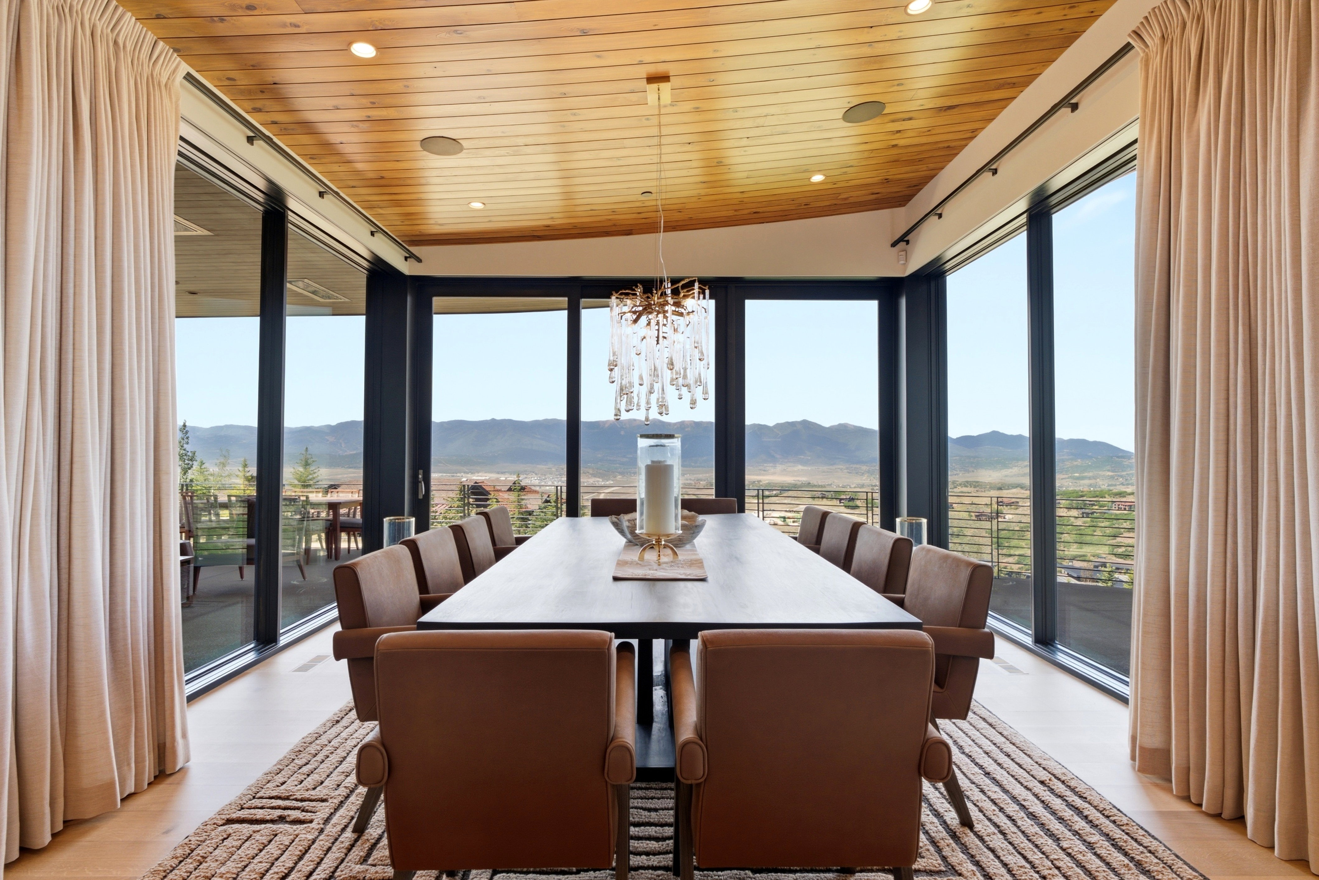 Dining area featuring a wood-panel ceiling, recessed lighting, and a crystal chandelier