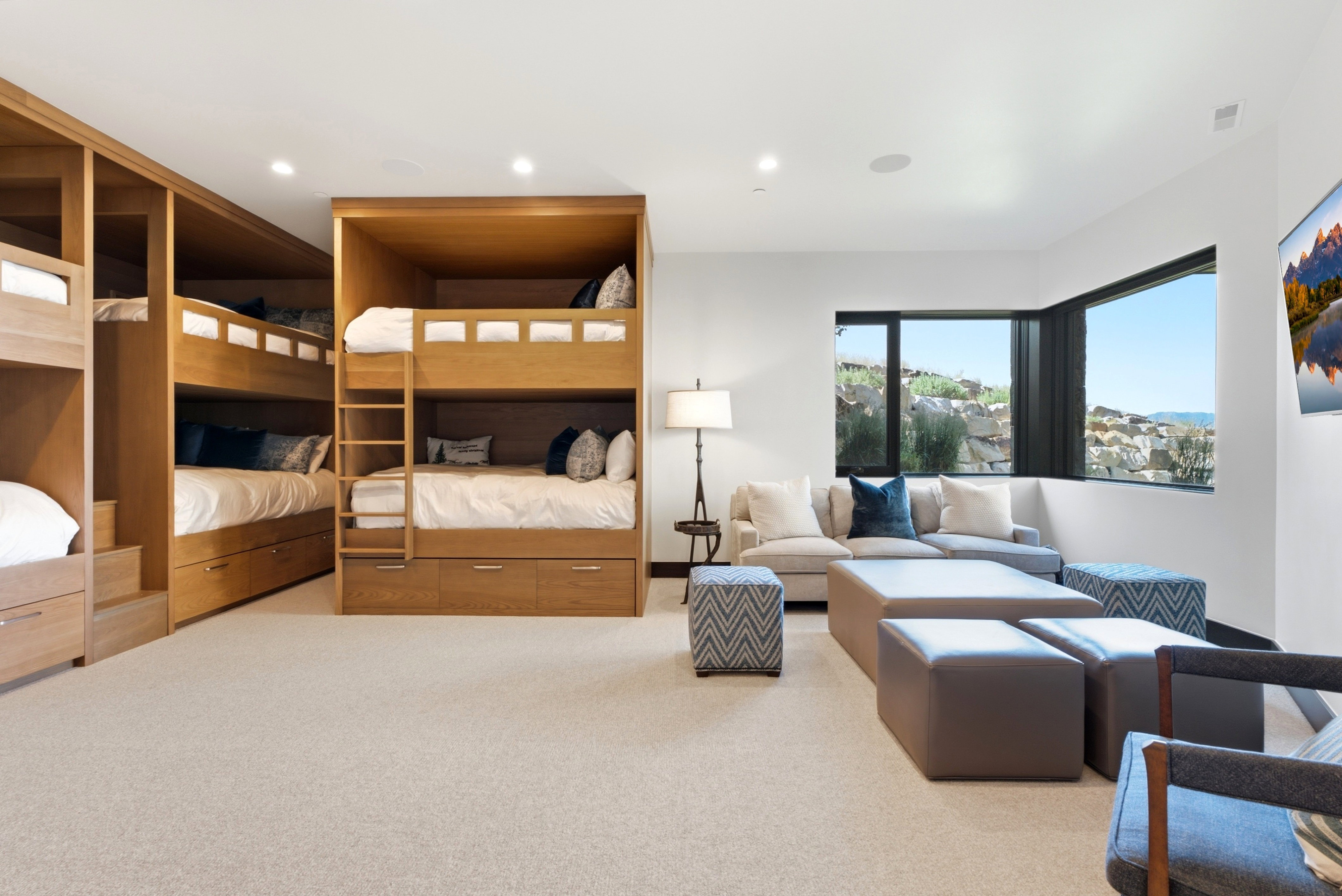 Accommodating room featuring multiple built-in bunk beds with integrated storage drawers