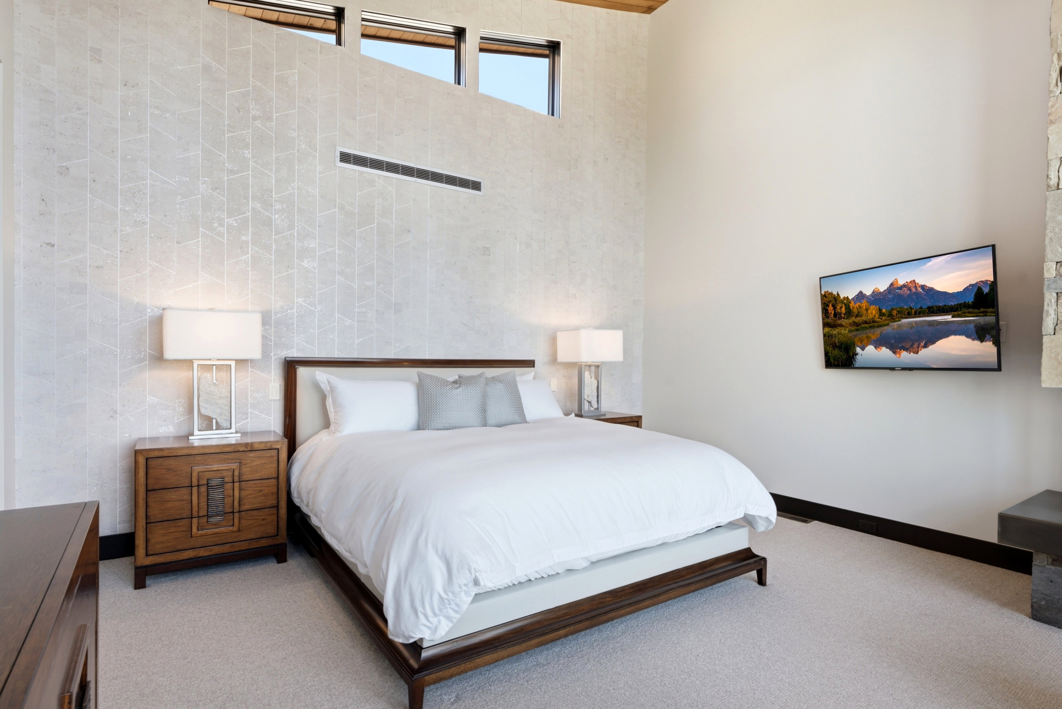 Vaulted ceiling with high transom windows and a patterned accent wall