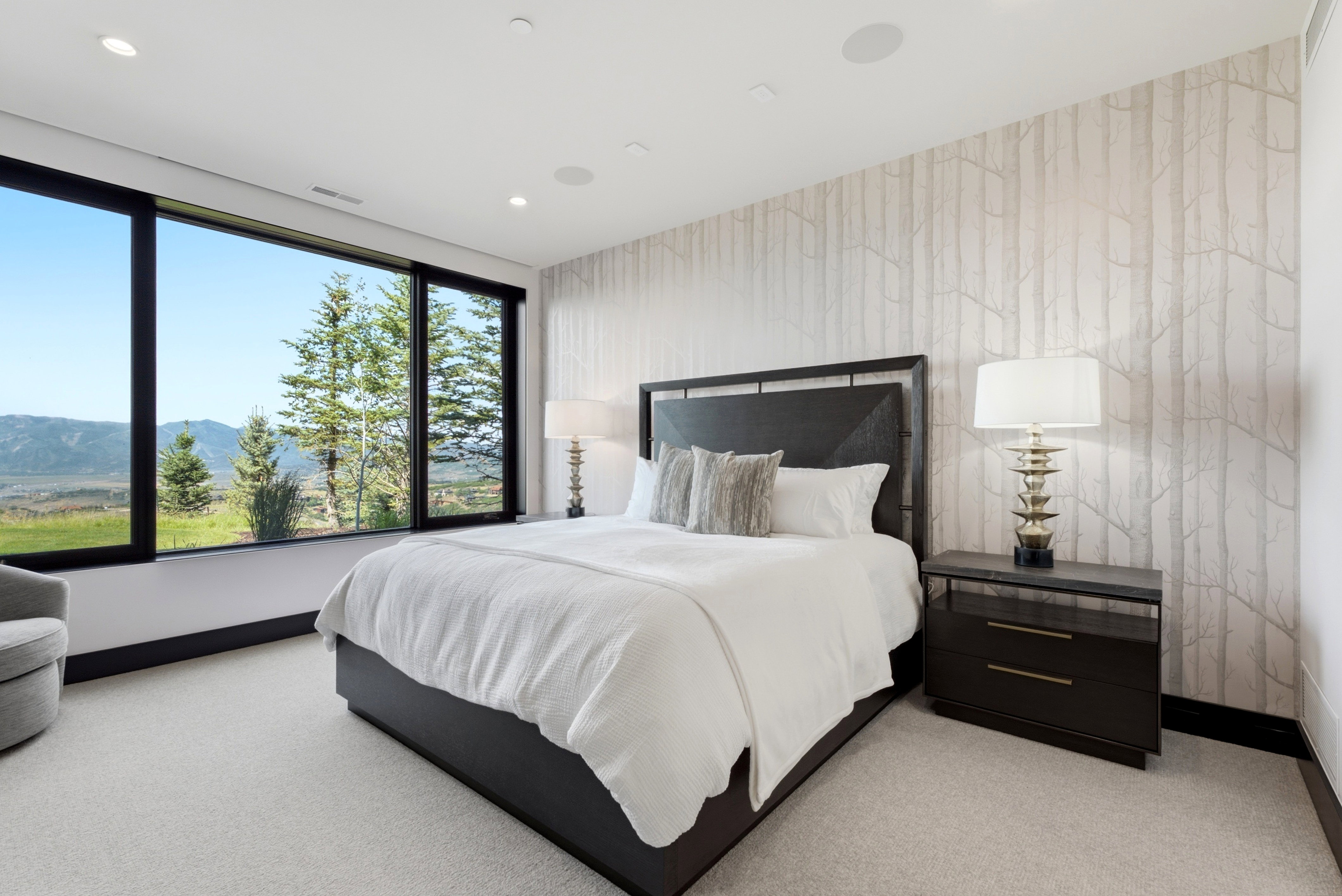 Expansive picture windows framing mountain and tree scenery