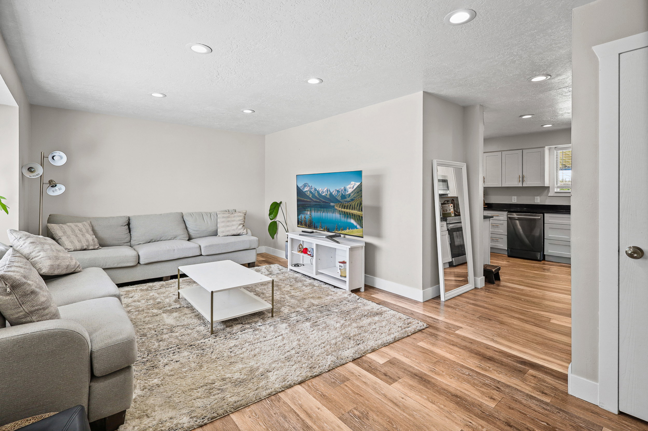 Living area featuring wood-finish flooring and recessed lighting