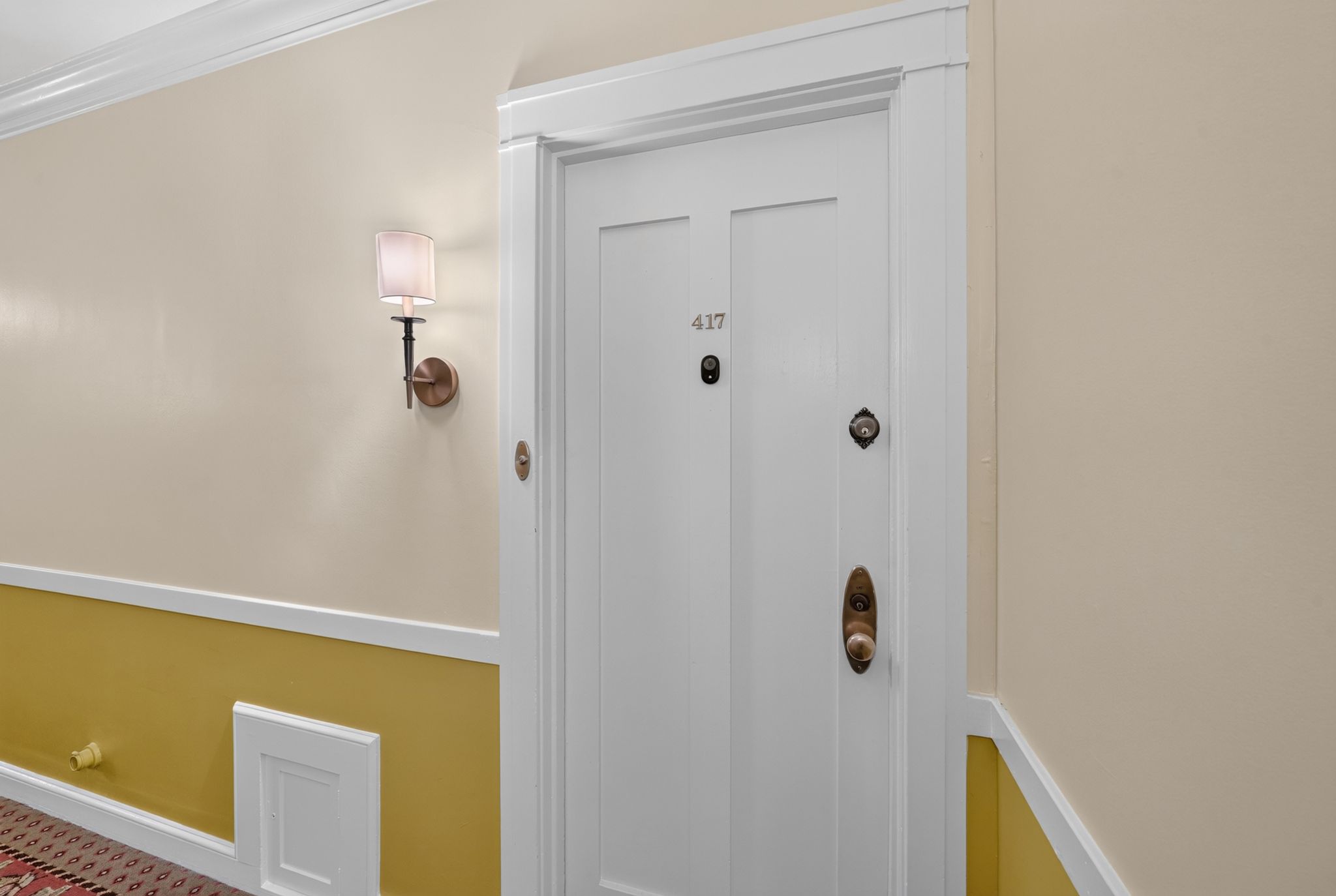 Entry door with recessed panels and brass hardware