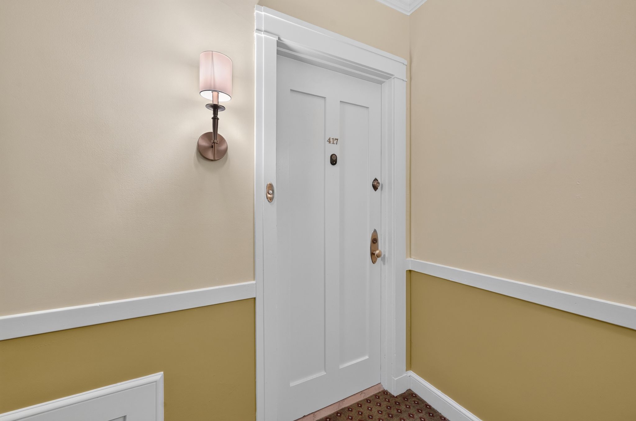Entry door with panel detailing and brass hardware