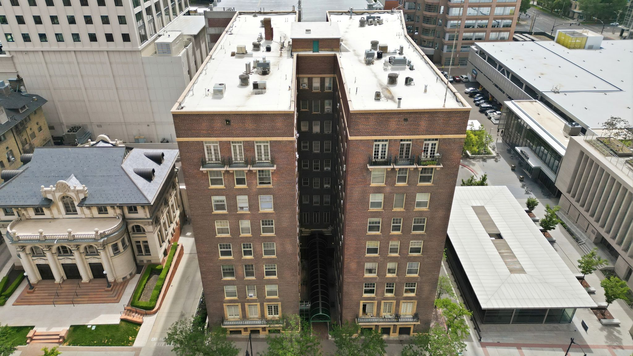 High-rise building with a brick facade and a multi-level roofline