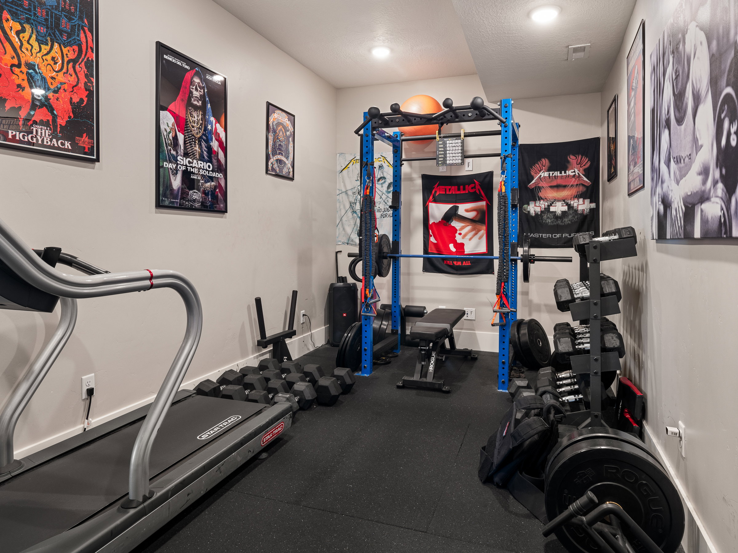 Dedicated fitness area featuring recessed lighting, light-toned wall paint, and durable black rubber flooring