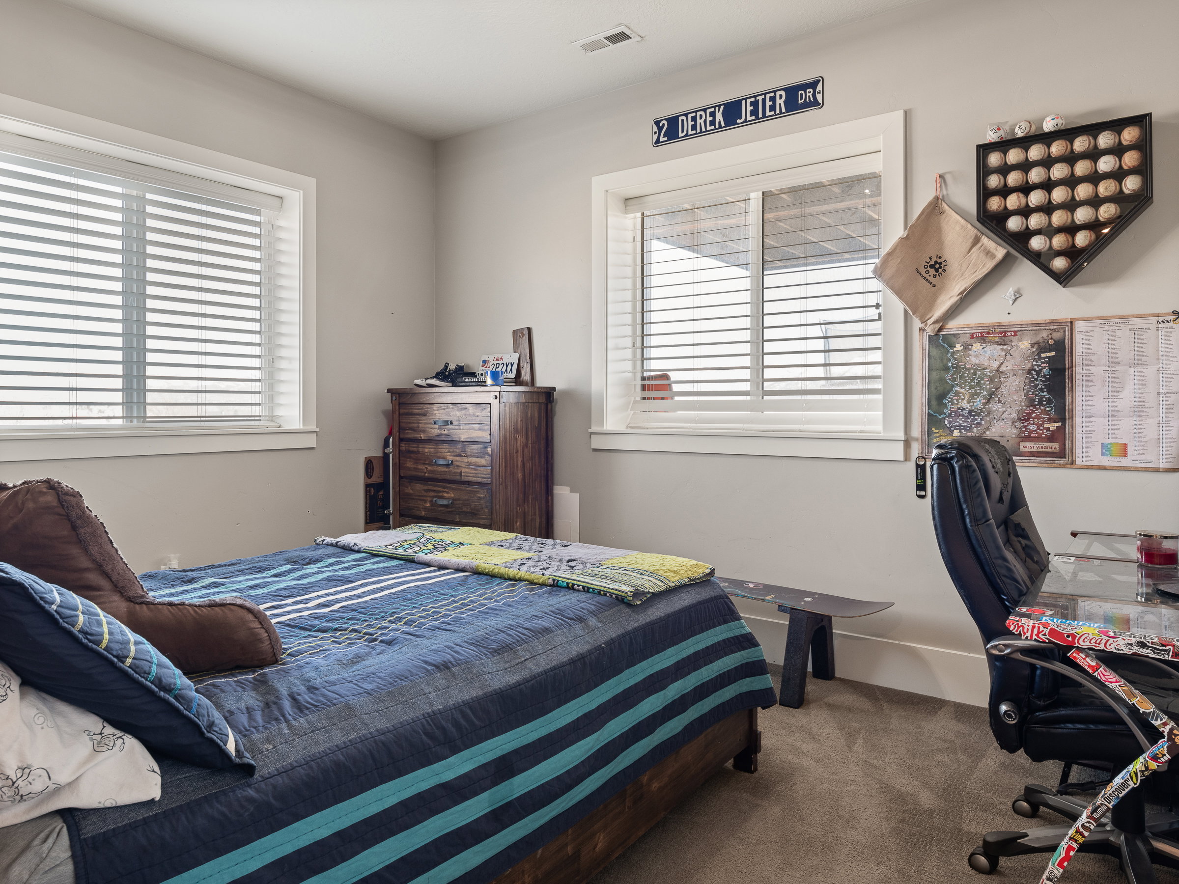 Bedroom featuring two windows with horizontal blinds and white trim