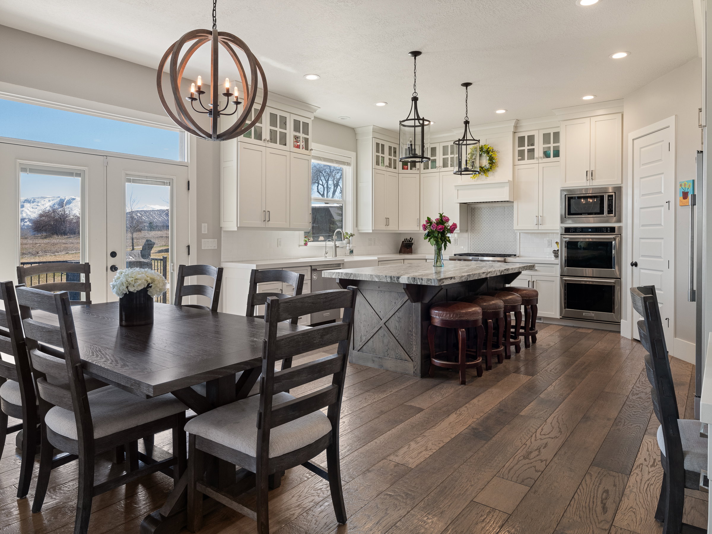 Open-concept kitchen and dining area featuring wide plank wood-finish flooring