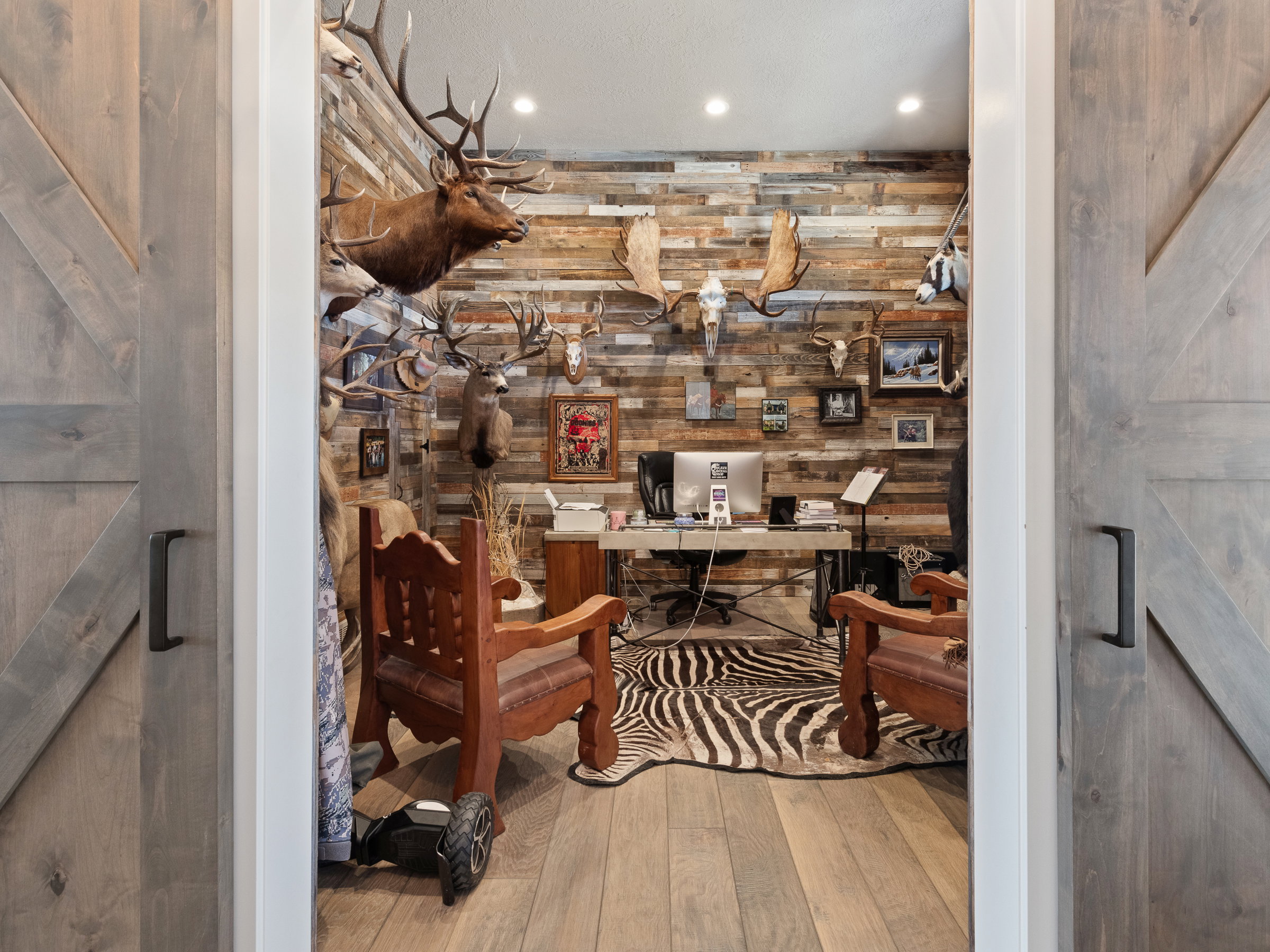 Office space featuring a wood-finish accent wall, recessed lighting, and wood-finish flooring