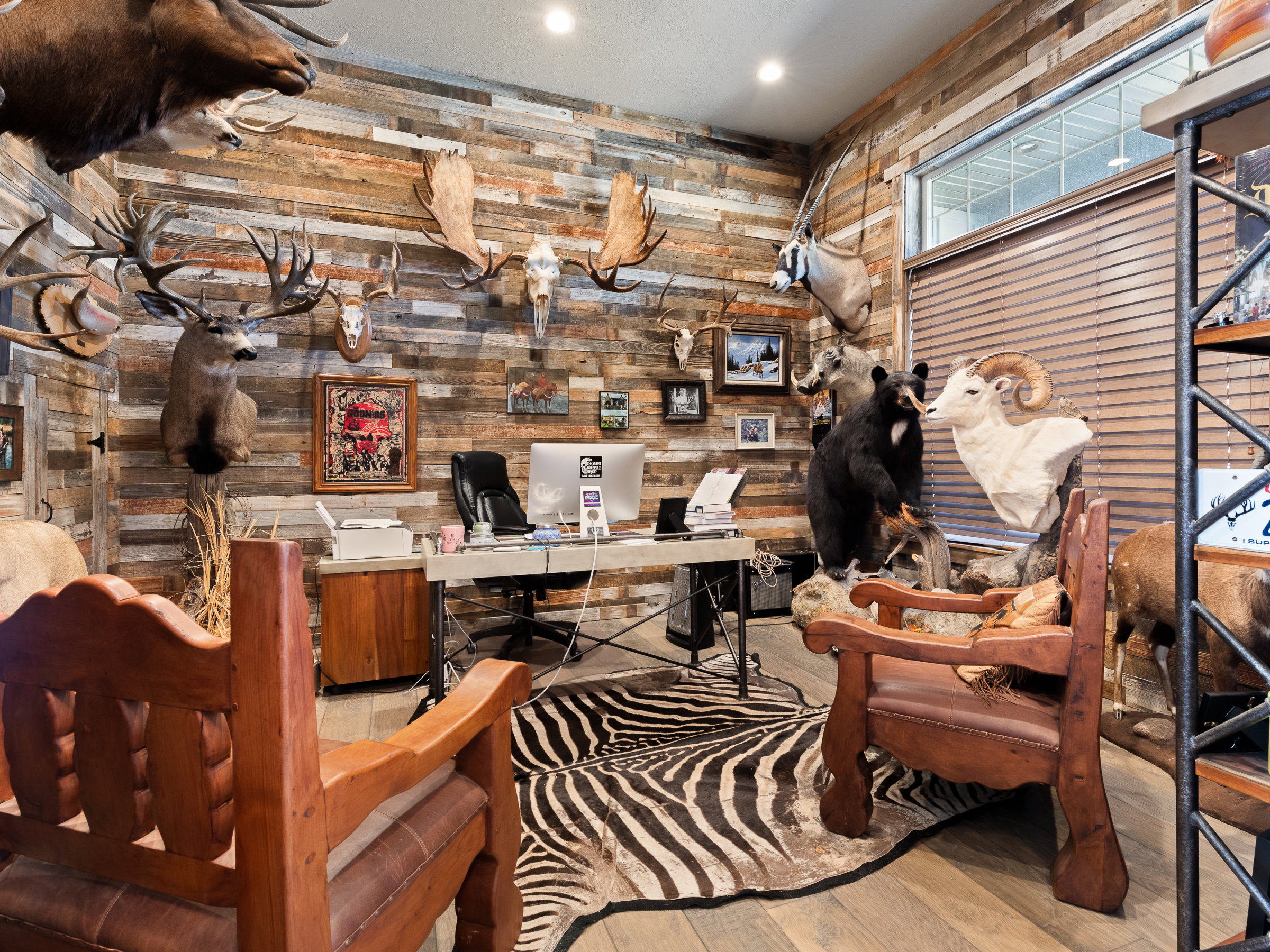 Office space featuring wood-finish accent walls, recessed lighting, and a window with horizontal blinds