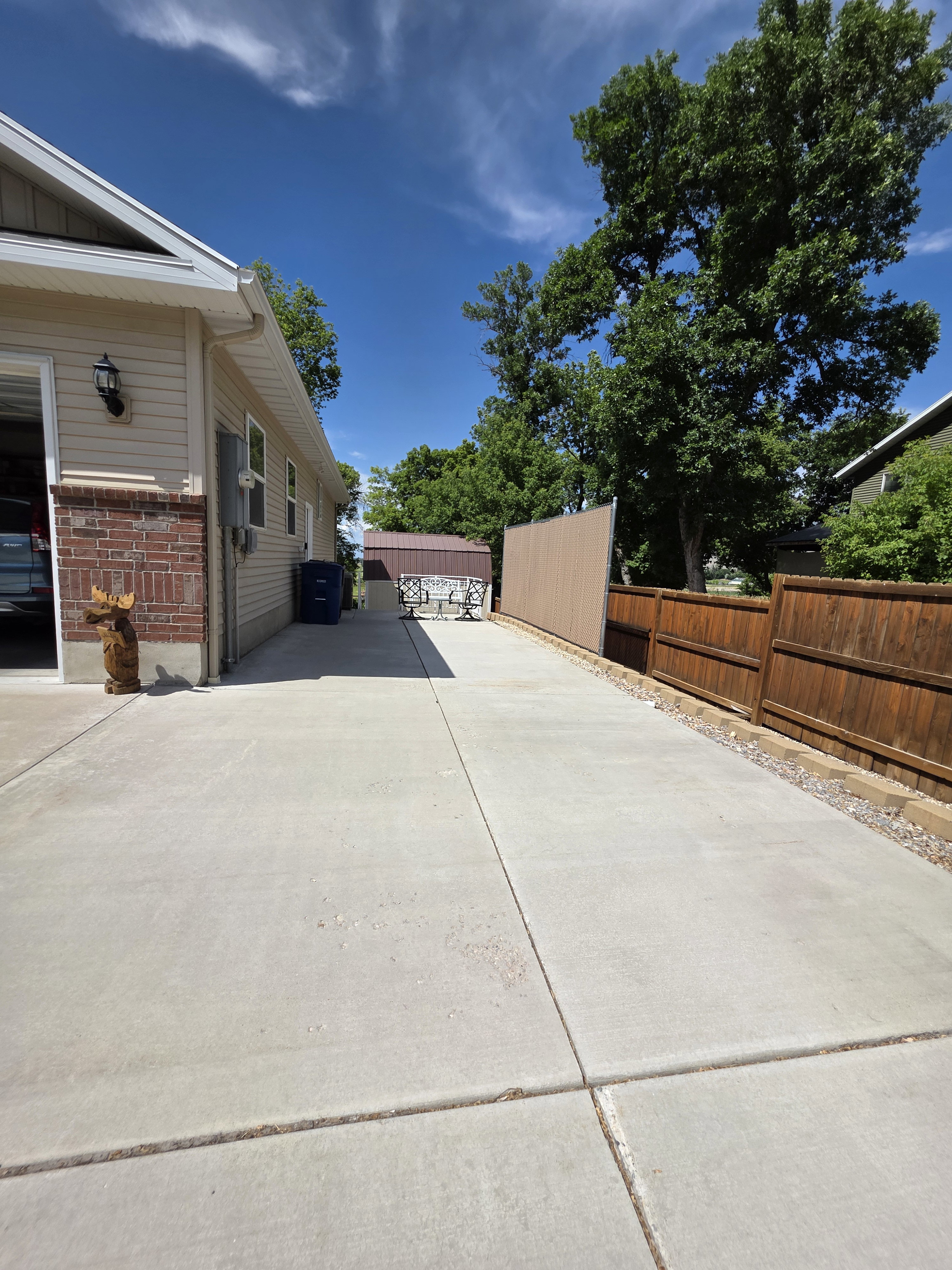 Expansive concrete driveway alongside the residence