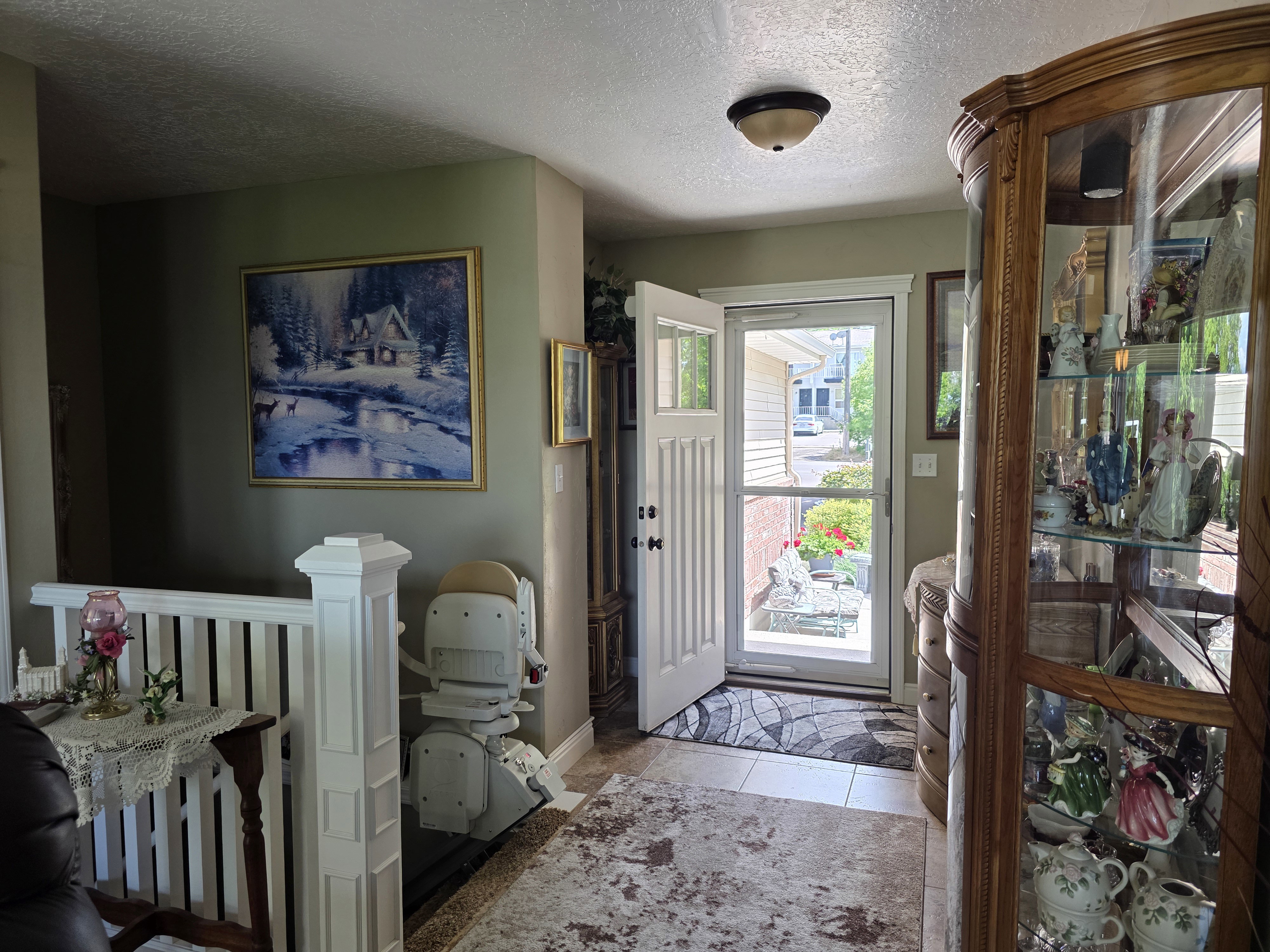 Entryway featuring a white paneled door with glass inserts, transom window, and an overhead flush-mount light fixture