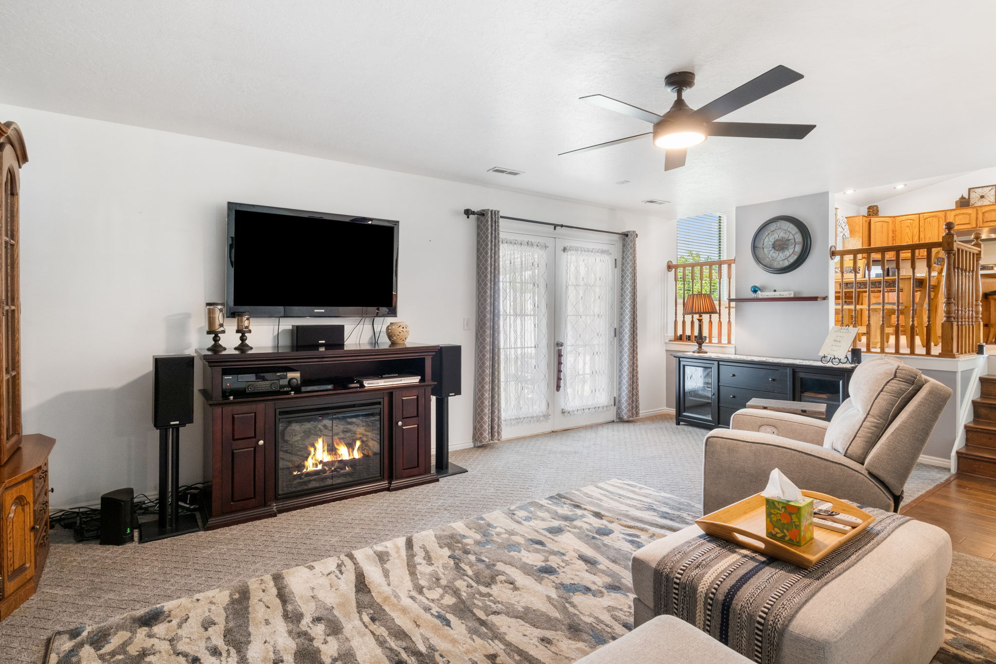 Living area featuring a ceiling fan, and French doors