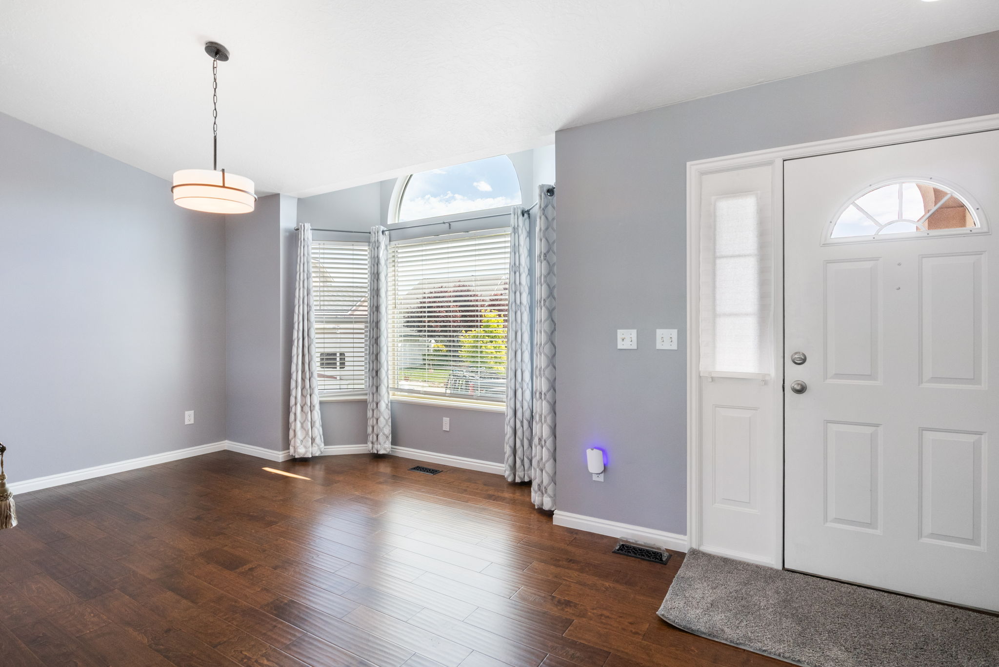 Engineered hardwood-finish flooring extending from the entryway